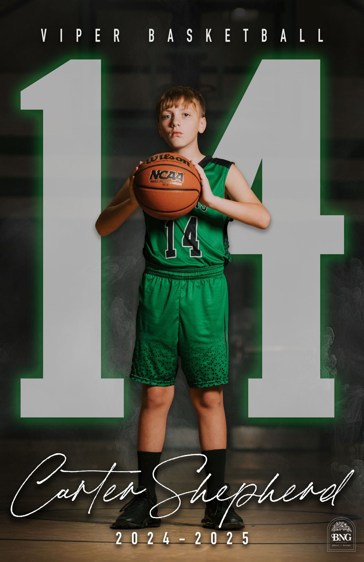 Youth basketball player in green Viper uniform holds ball against dark backdrop with dramatic lighting and number 14 visible.