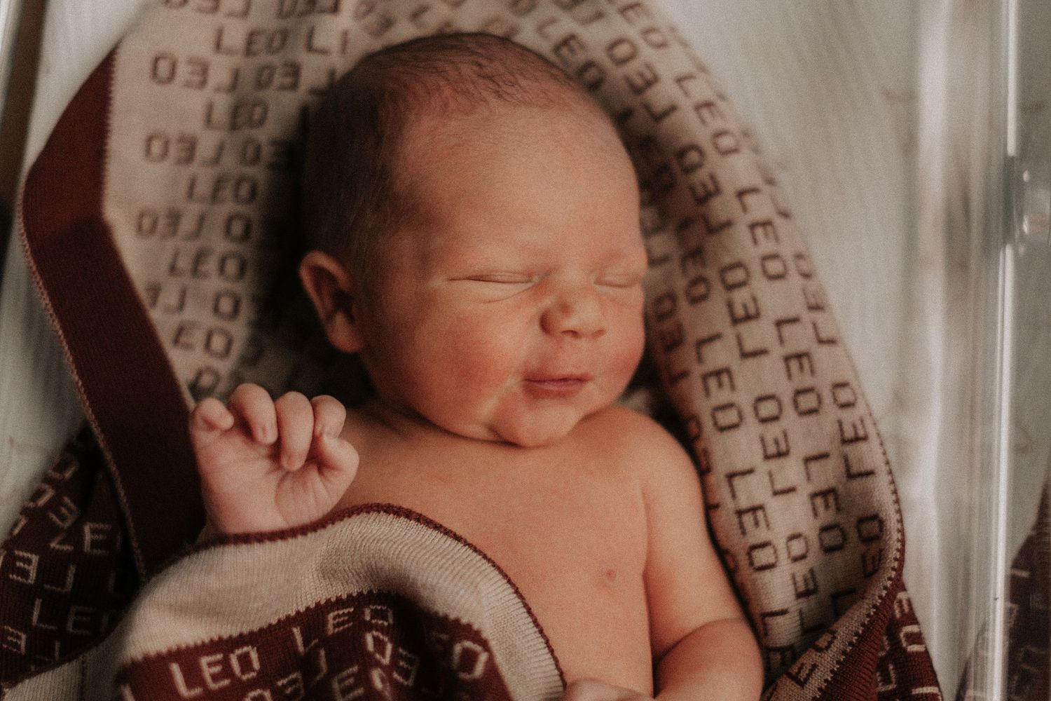 Peaceful sleeping newborn in soft natural lighting.