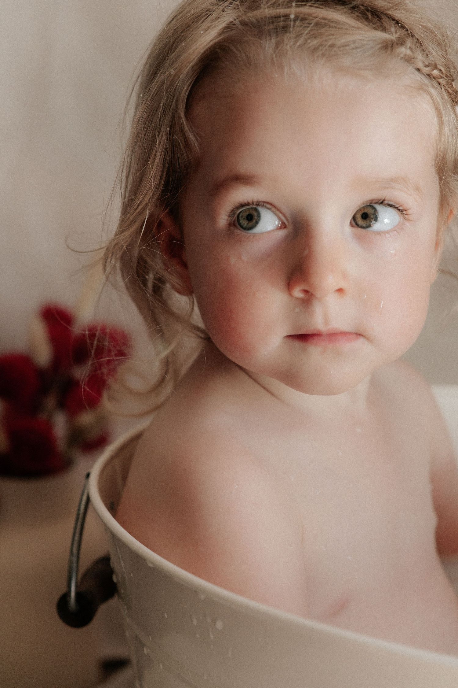Close-up portrait sequence showing a child peeking over a white surface.