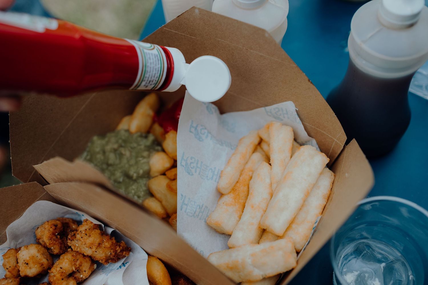 Assorted party food and snacks served in paper containers.