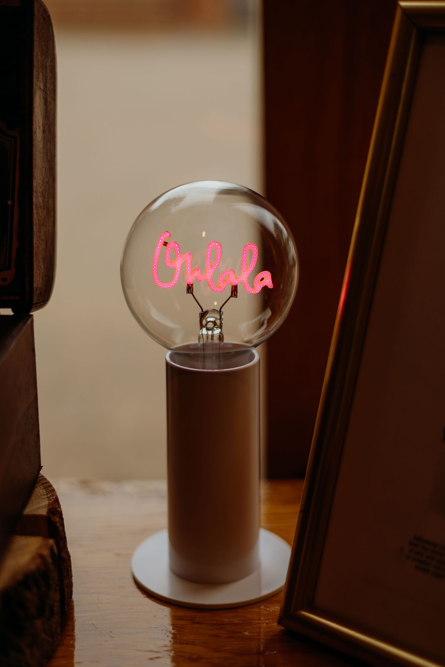 Pink neon light glowing inside clear glass bulbs creates an ambient atmosphere.