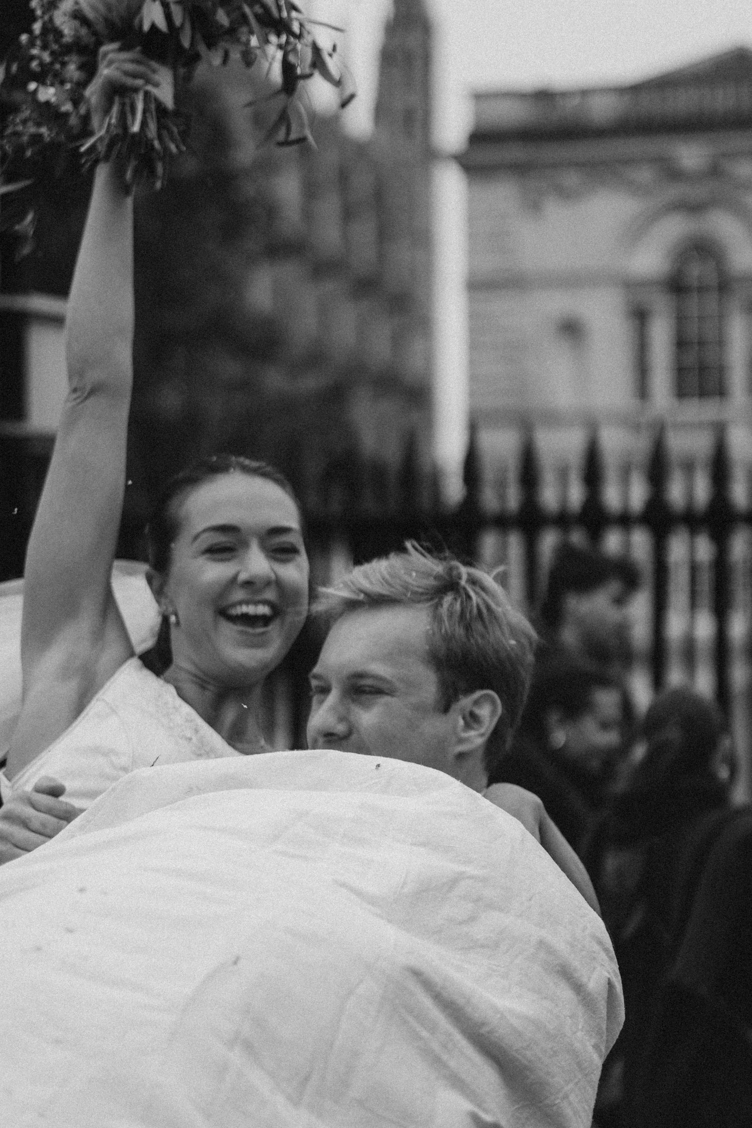 Black and white candid celebration moment with joyful expressions and movement.