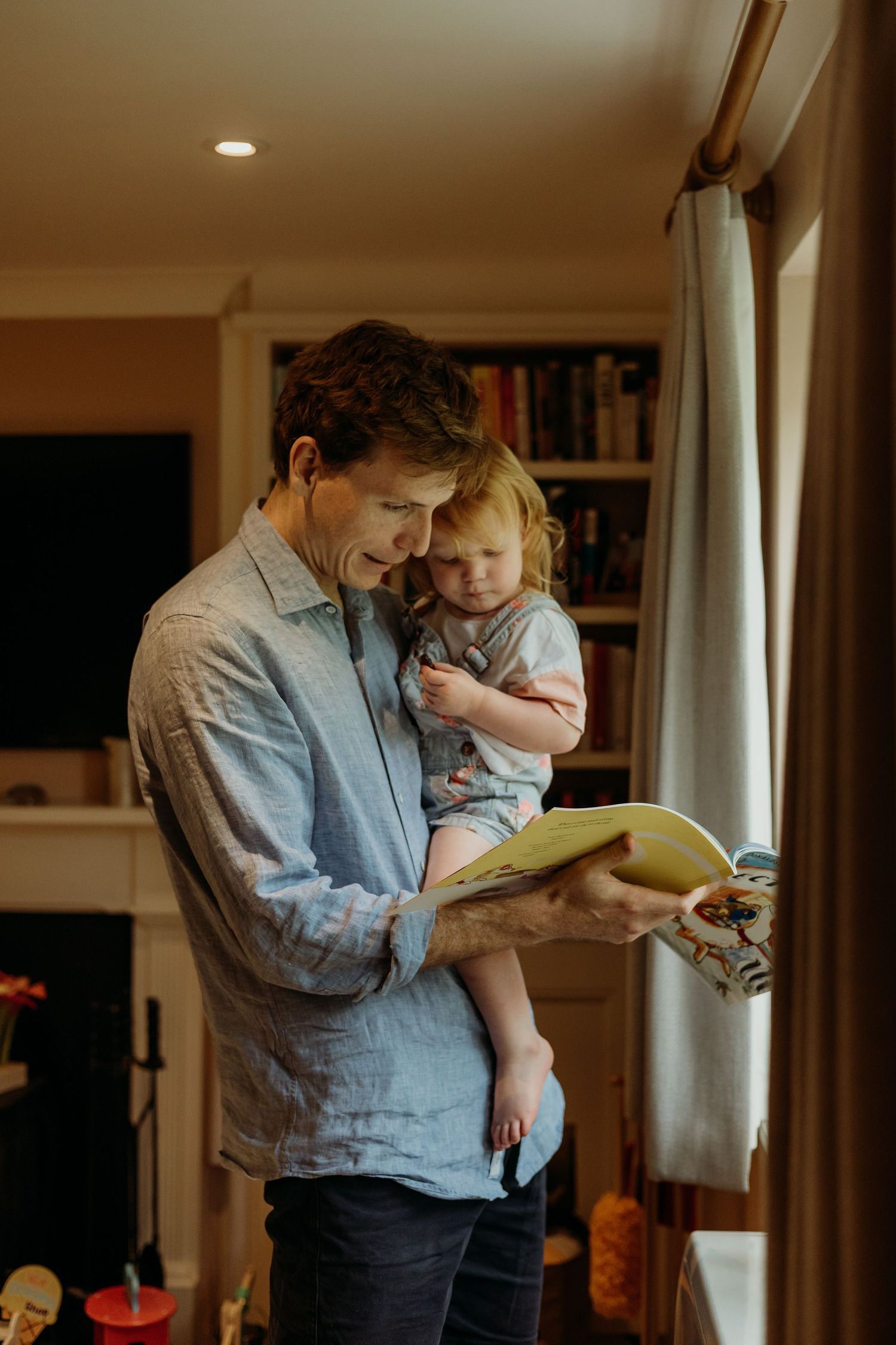 Reading time together with a book in a cozy home setting.