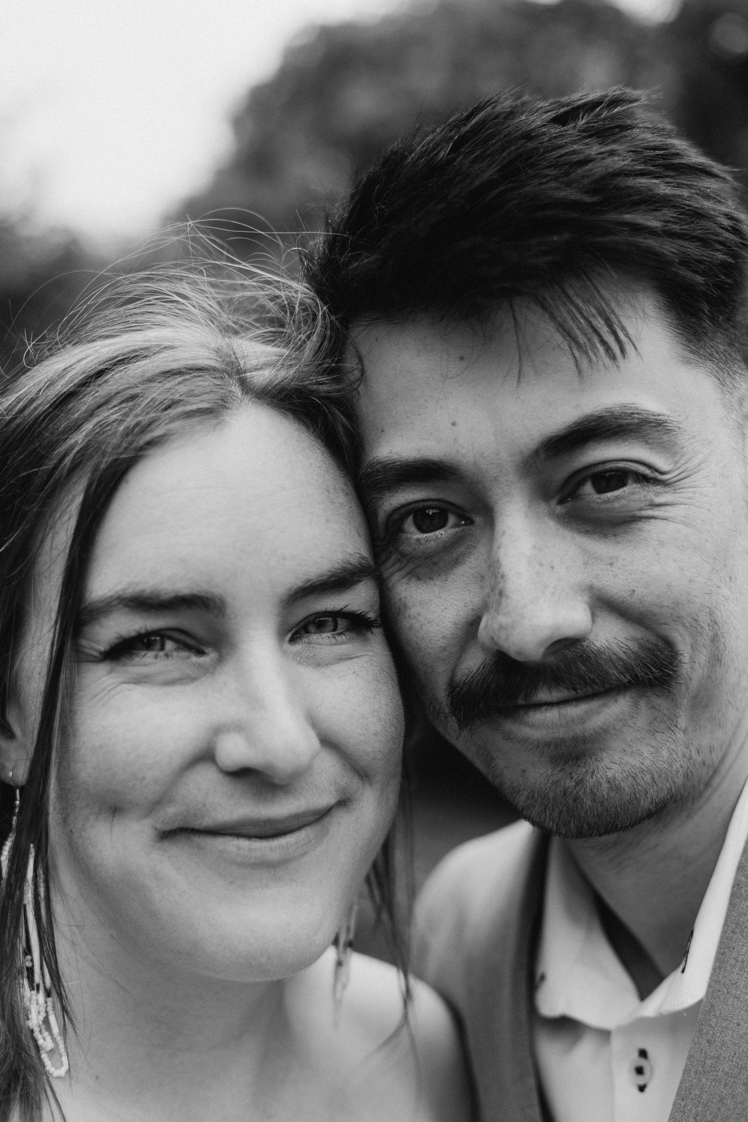Close-up black and white portrait showing joyful expressions.