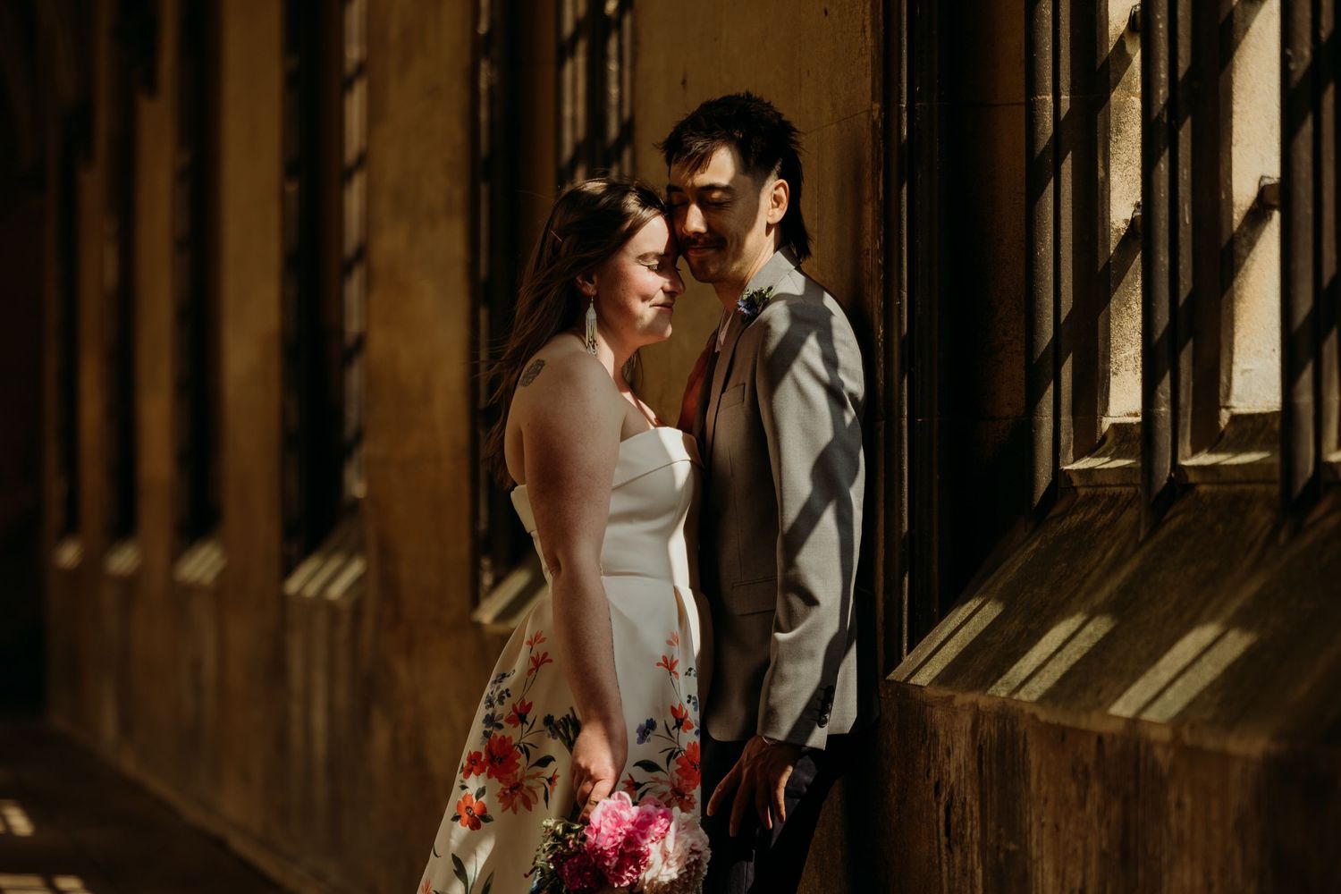 Couple shares tender moment in rustic wooden interior with natural light streaming through.