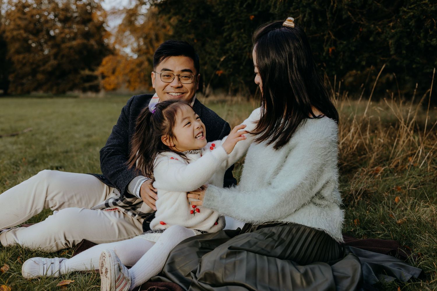Family having fun together outdoors during an autumn photoshoot.