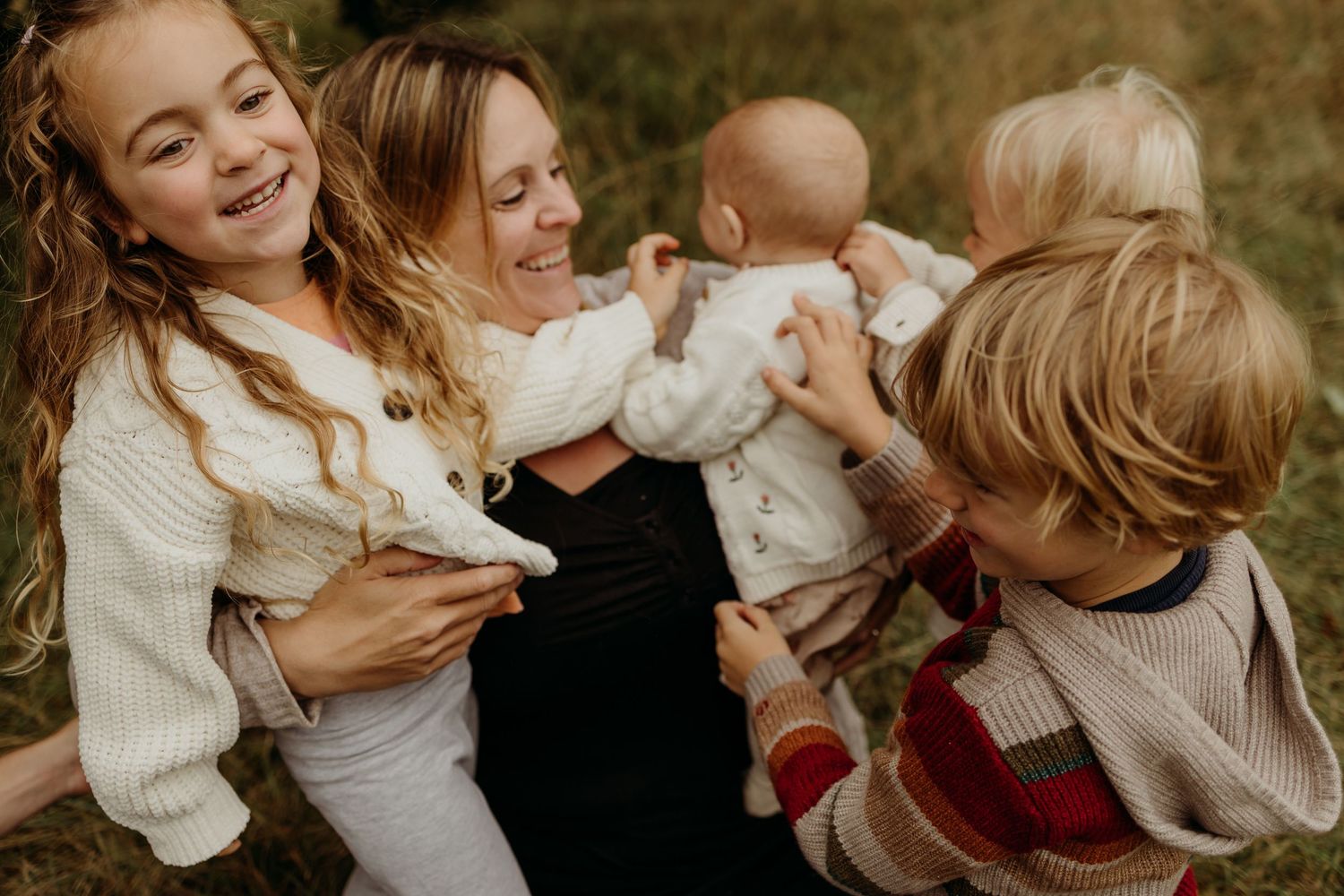 A heartwarming collection of family photos showing tender moments between parents and children in cozy sweaters.
