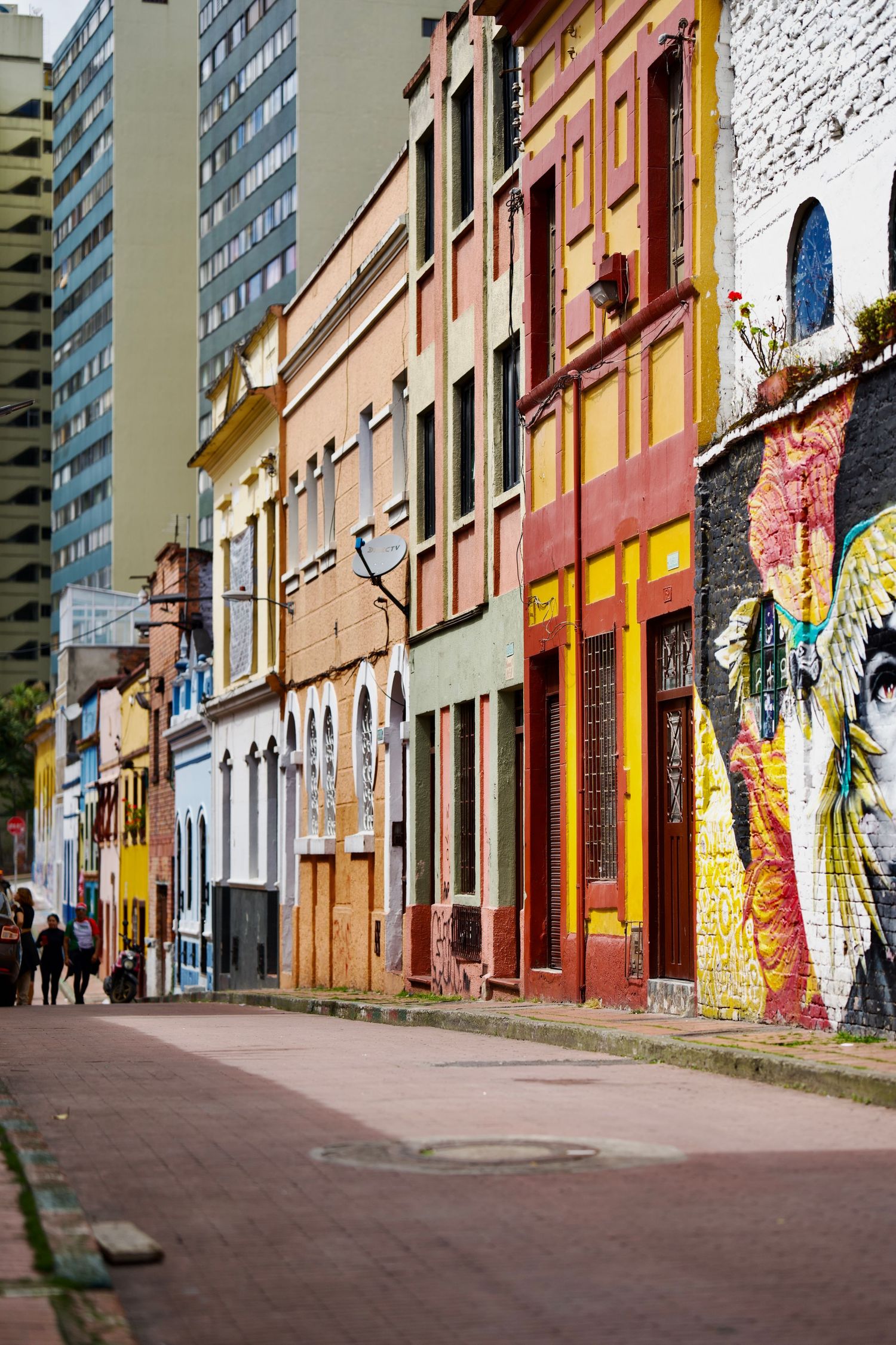Colorful street with graffiti murals and urban art on building facades.