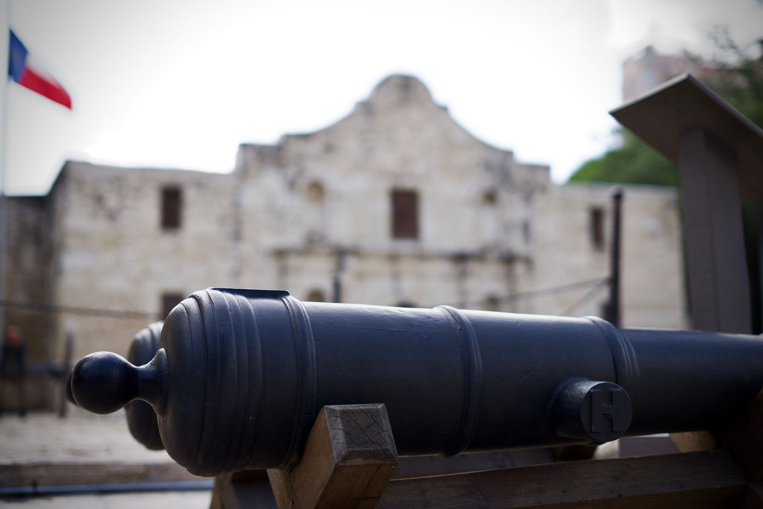 Historic stone fortress wall with mounted cannon in defensive position.