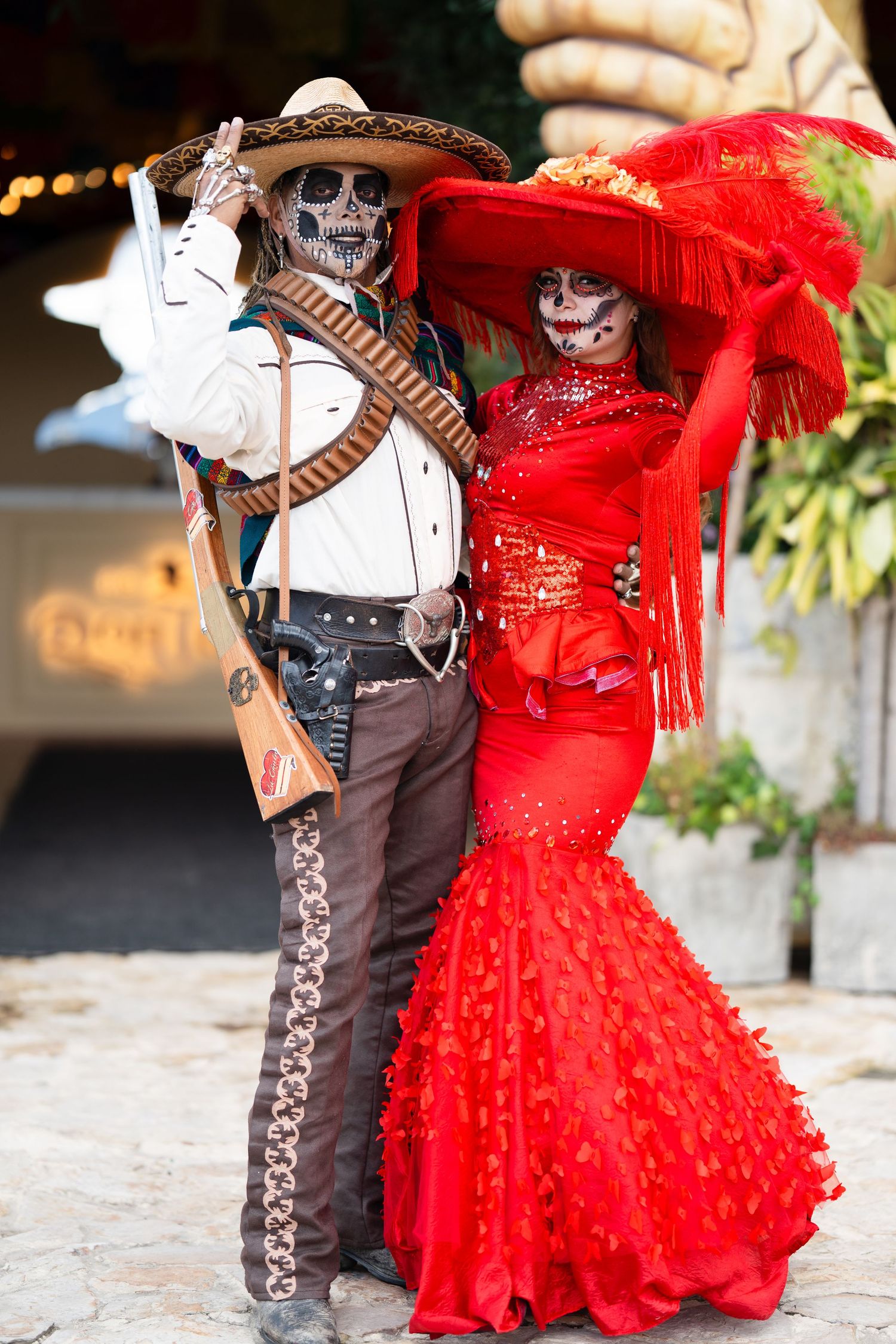Traditional Mexican dancers in Dia de los Muertos costumes performing together.