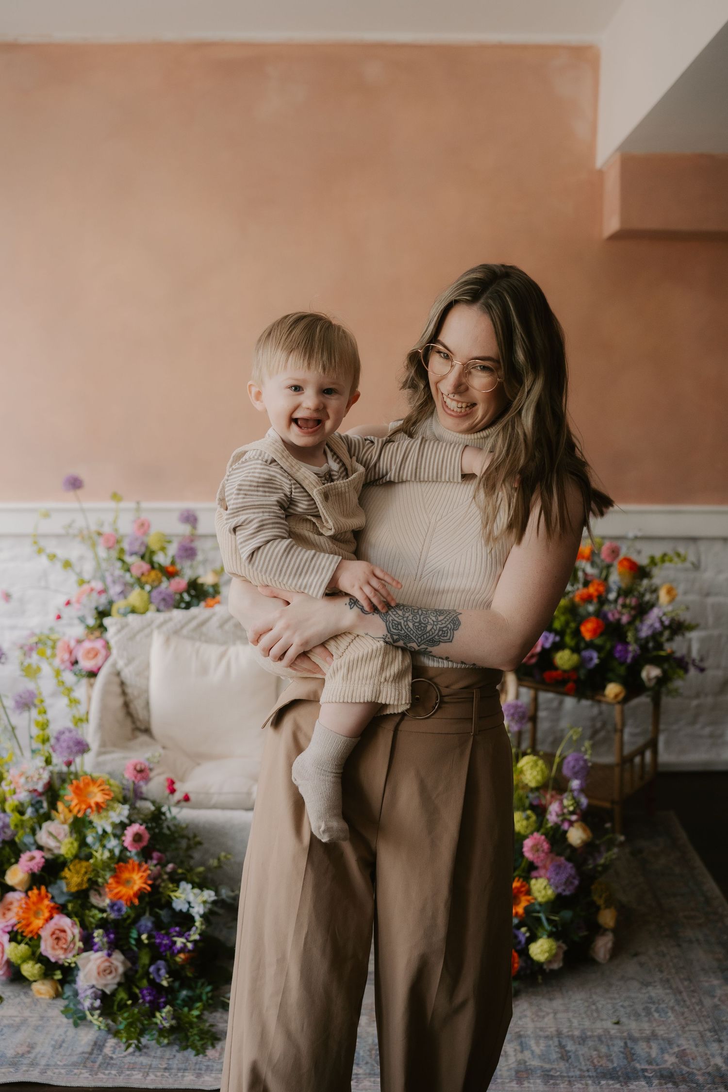 mother holding child on hip laughing