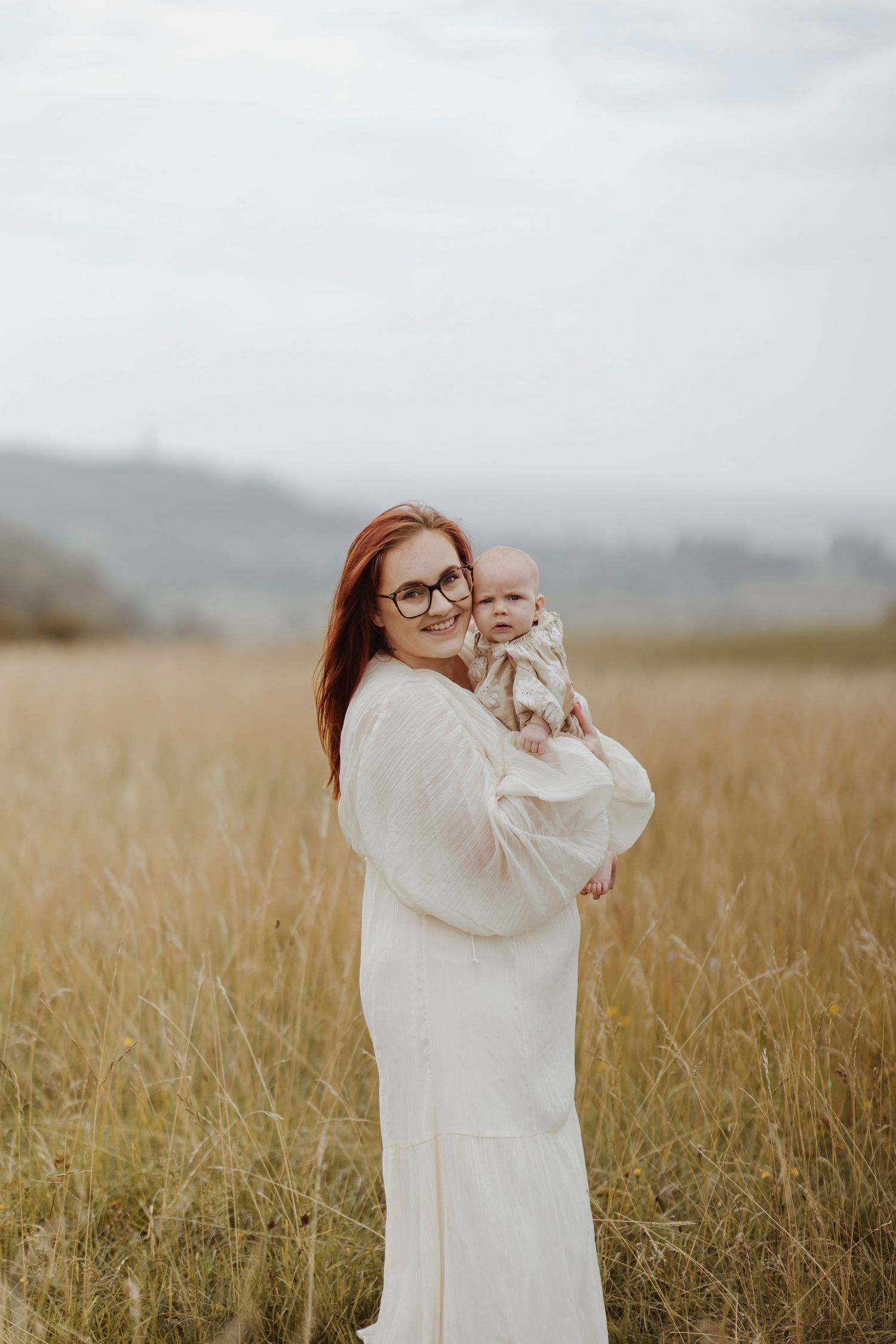 mother and daughter hugging in the long grass