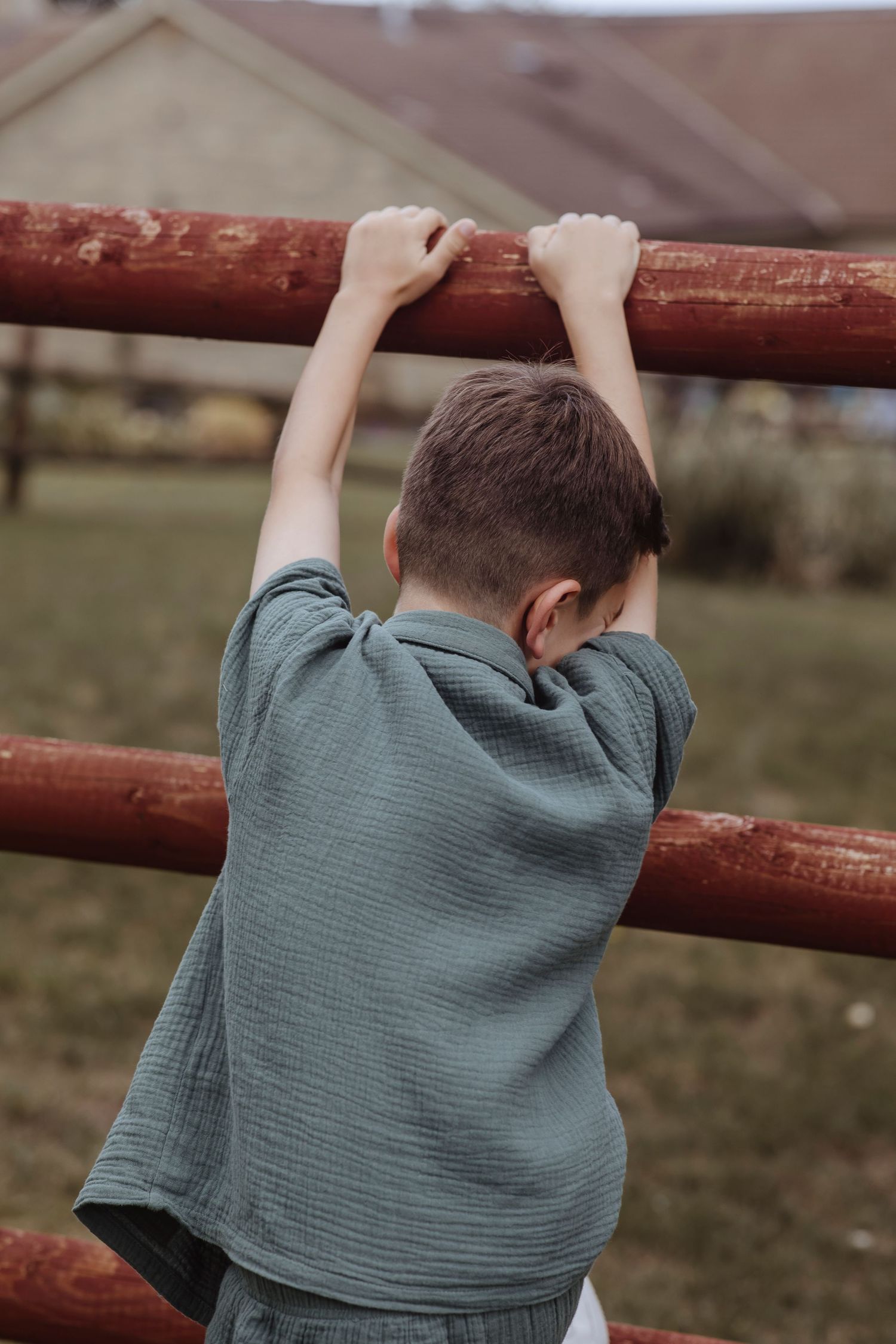 child playing hide and seek in the garden with their sister