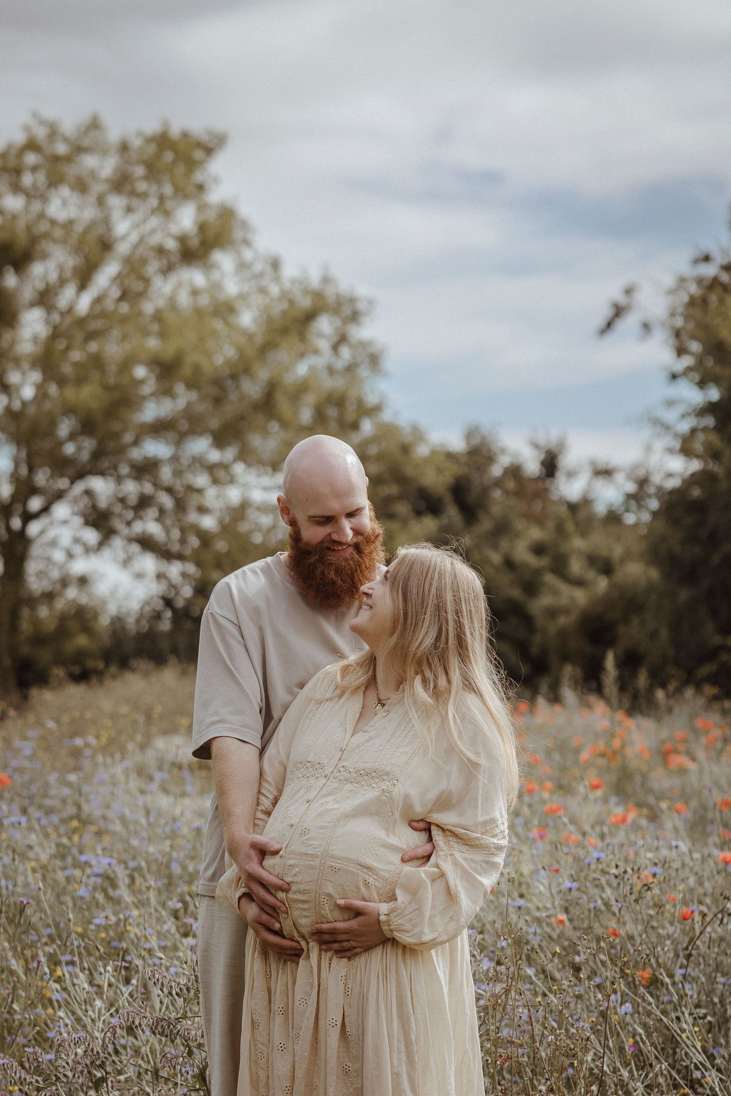 A quiet moment of love and expectation, wrapped in soft light and wildflowers.