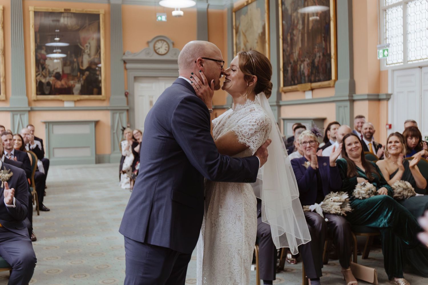 bride and grooms first kiss during ceremony