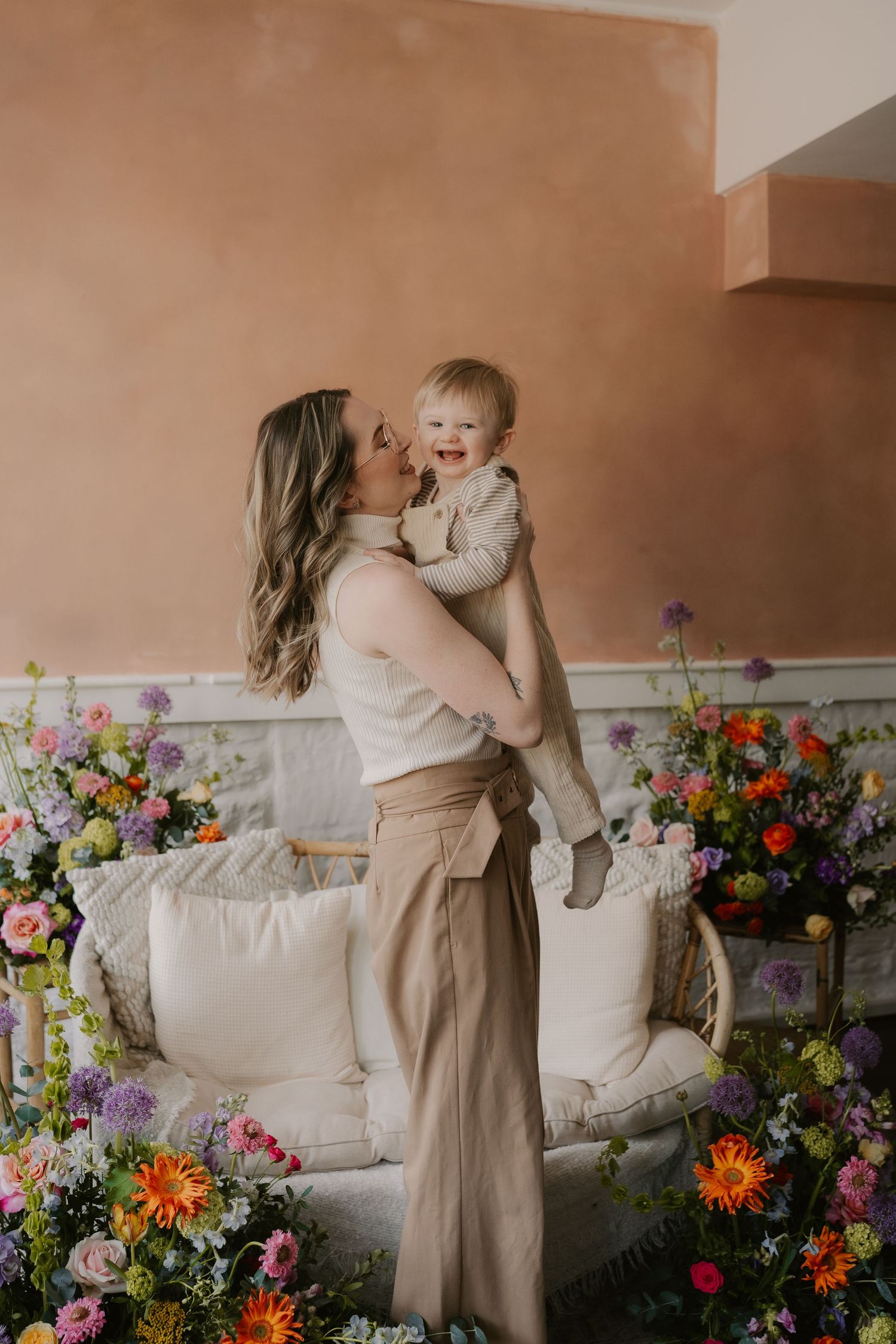 mother holding child face to face and smiling