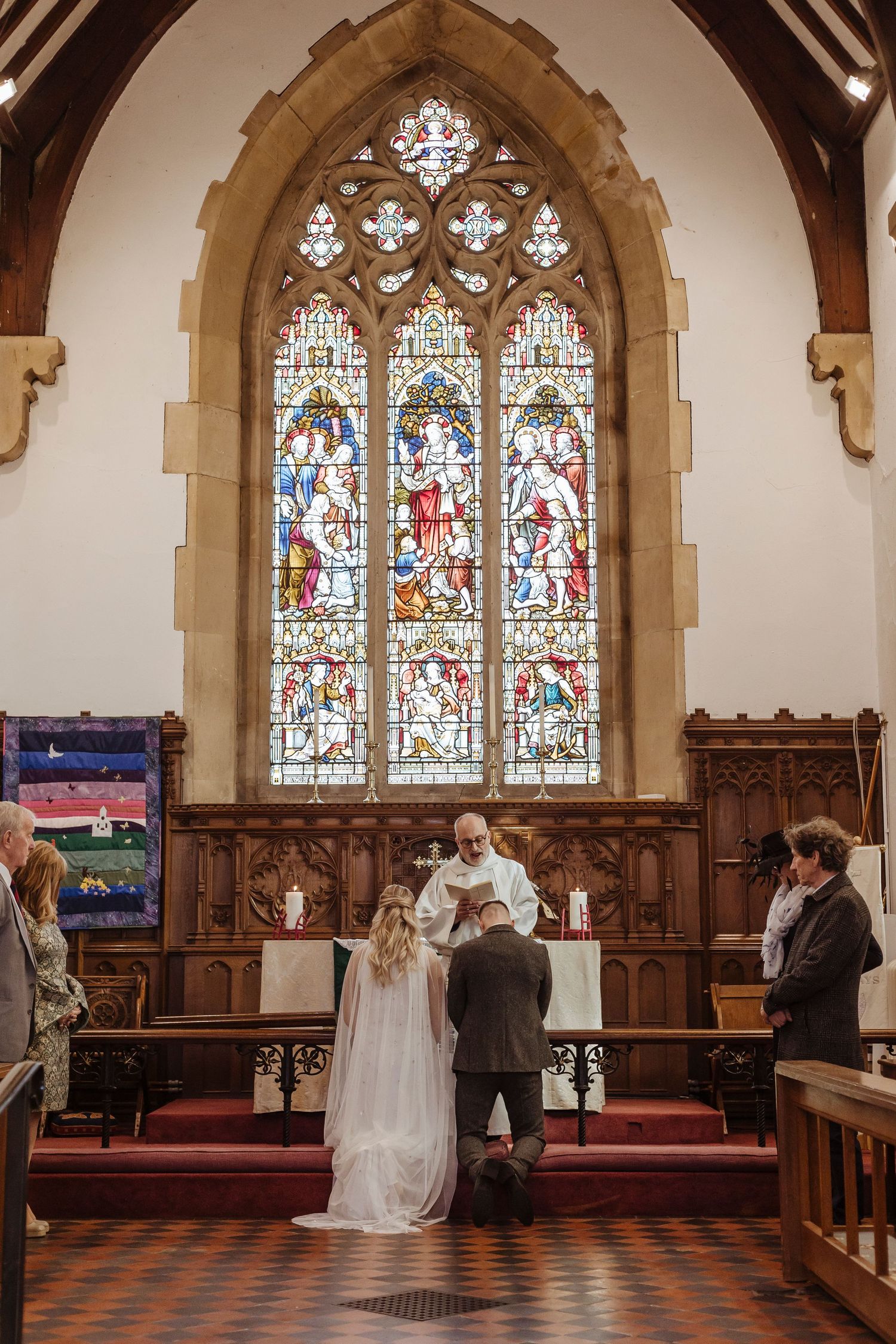 bride and groom knelt down in the church.