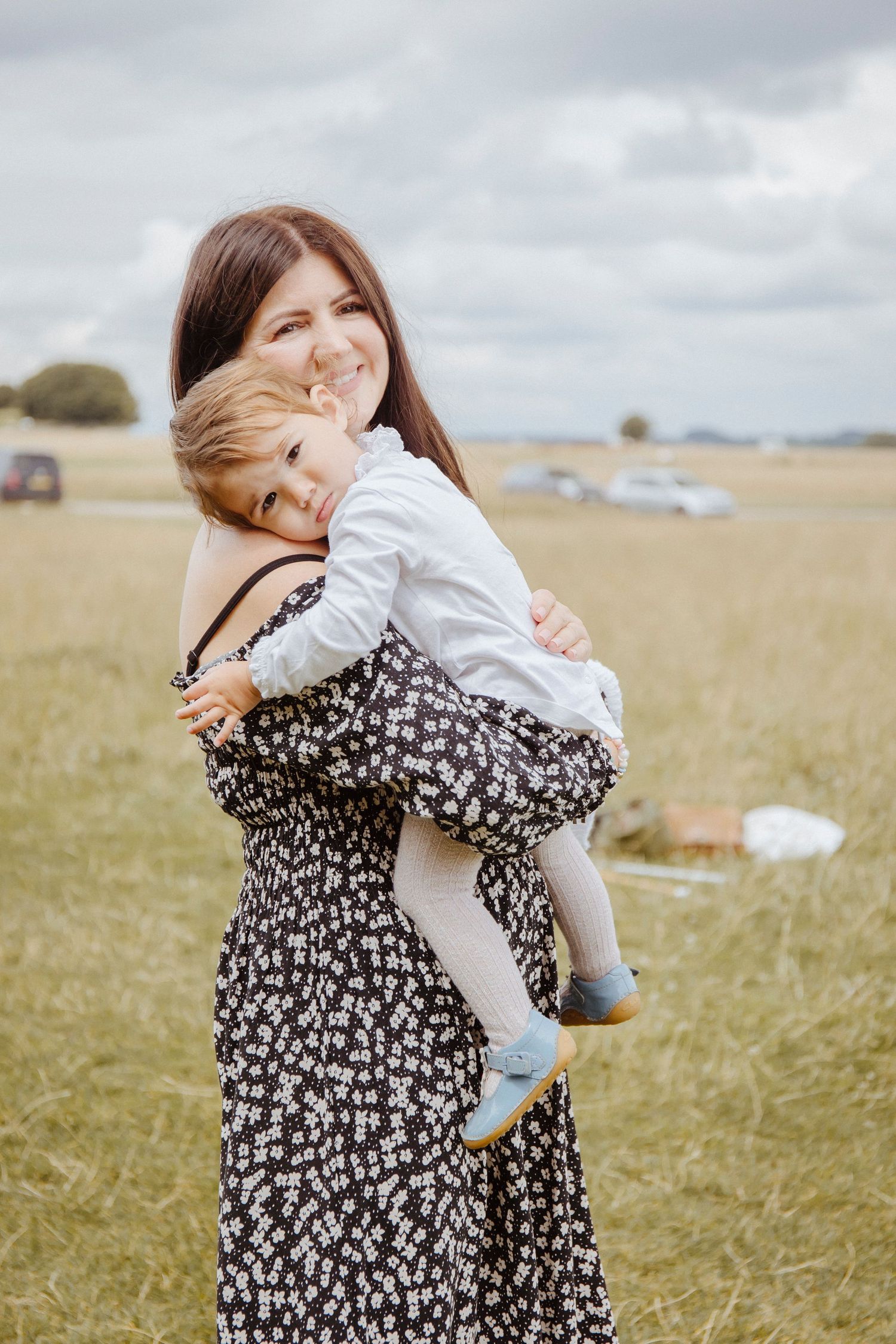 daughter hugging her mother with her head resting on her shoulder