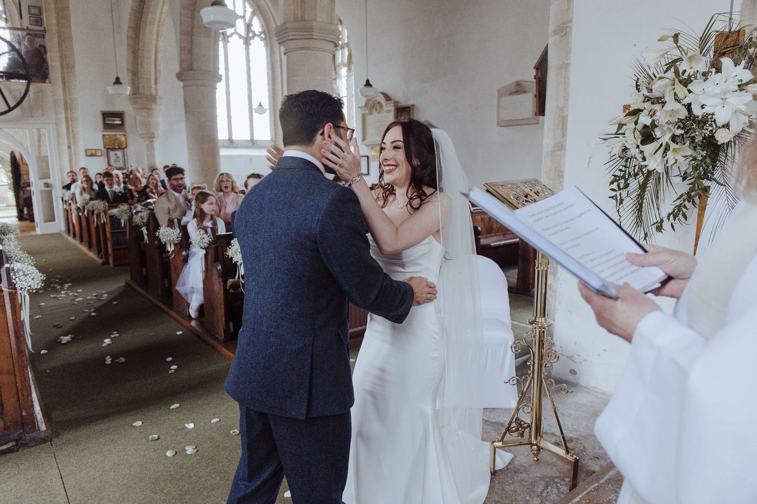 bride and groom about to kiss in the church
