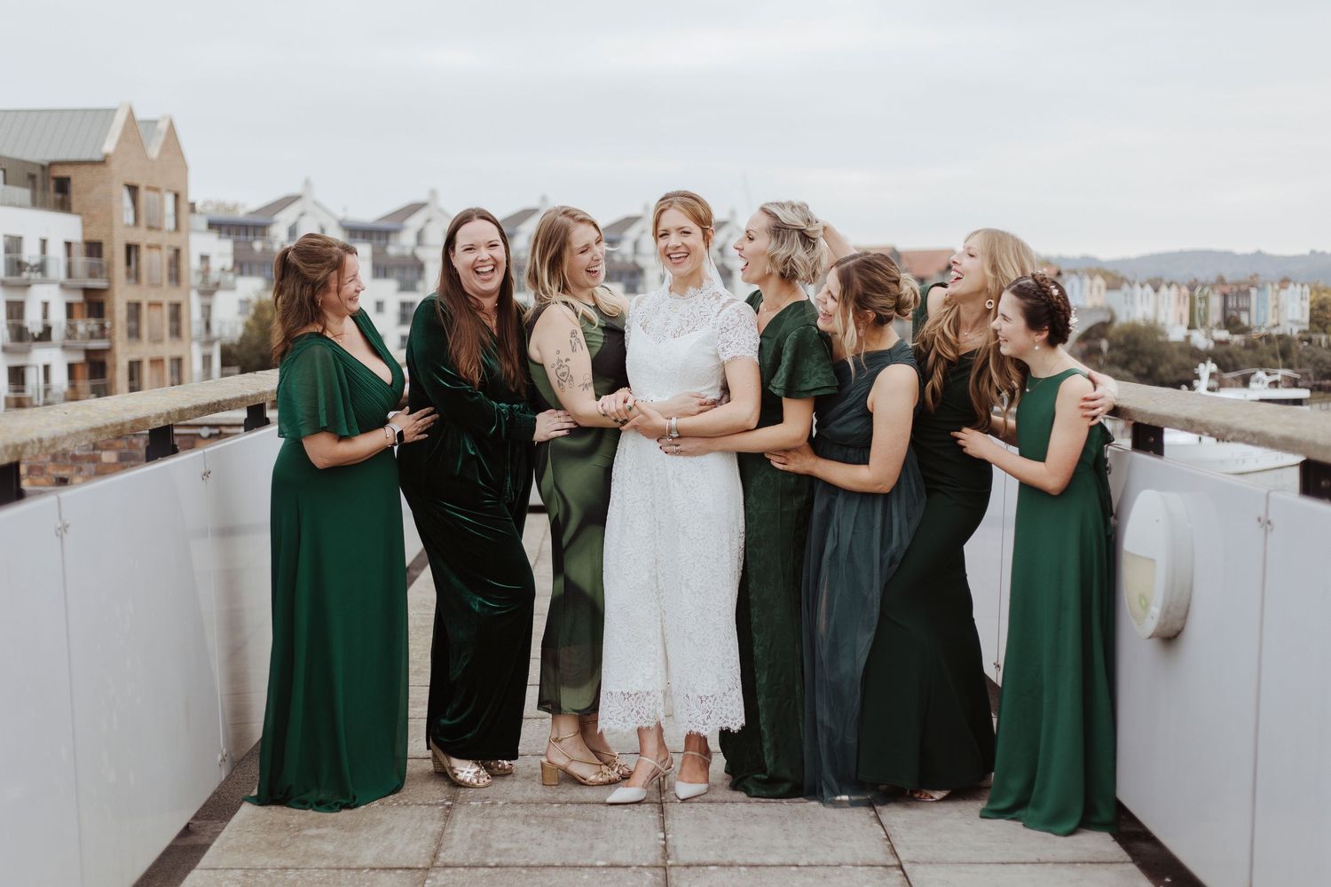 bridesmaid group photos all looking and smiling at the bride