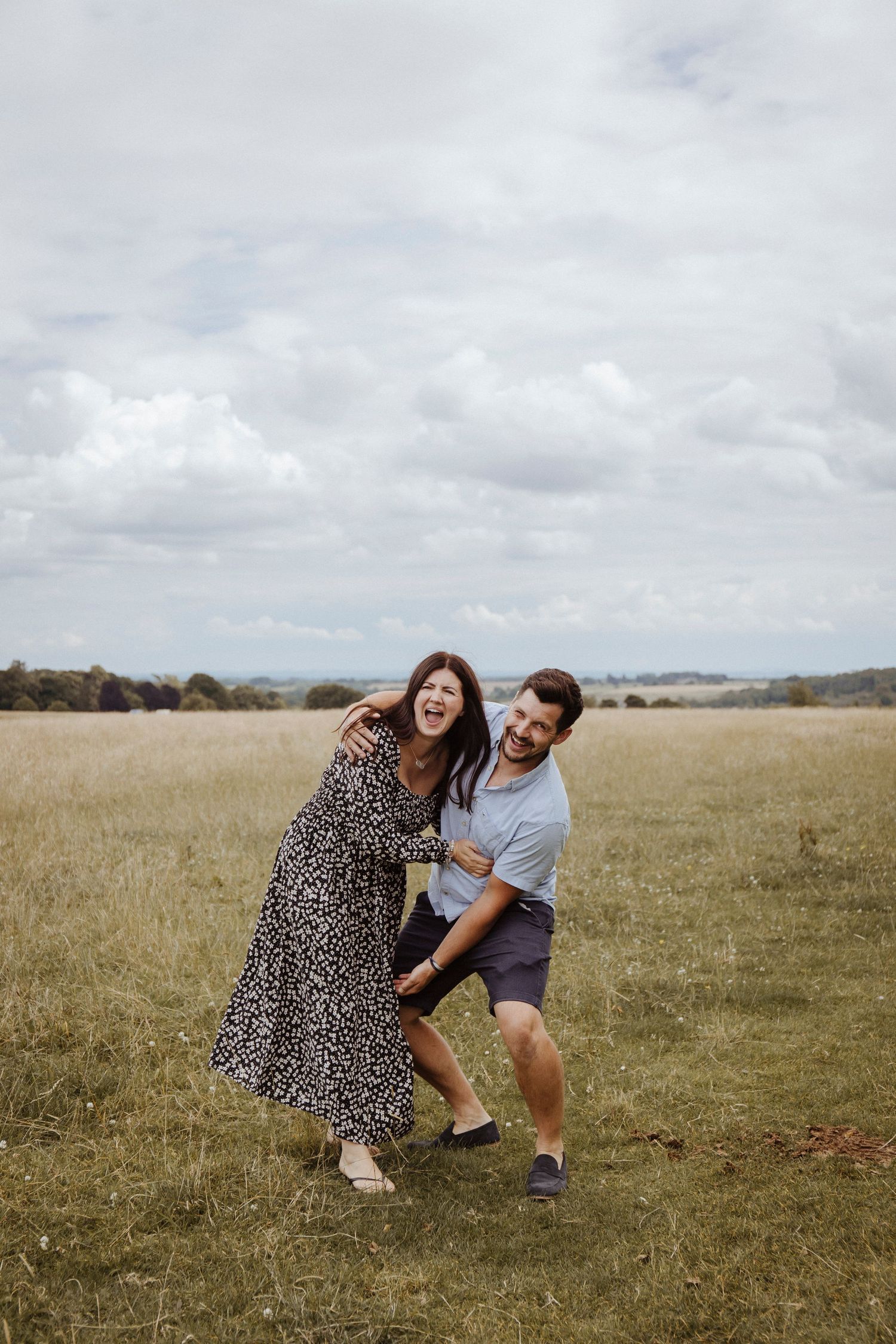 couple laughing and playing in the countryside