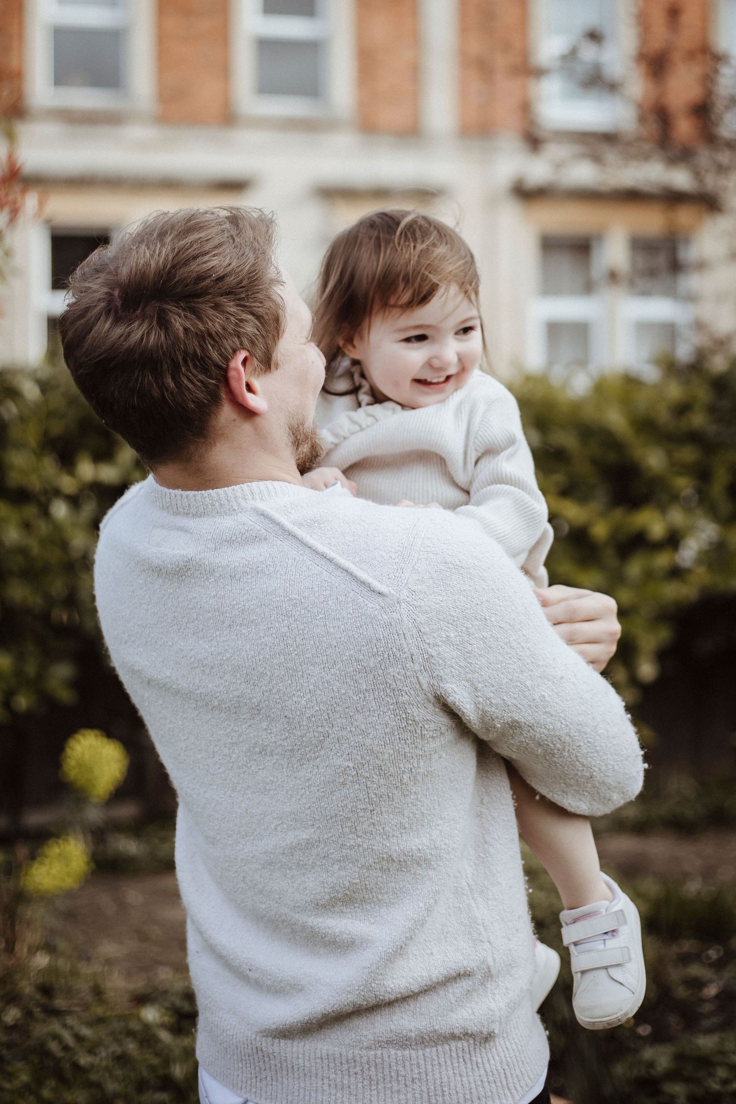 father and daughter playing in the garden