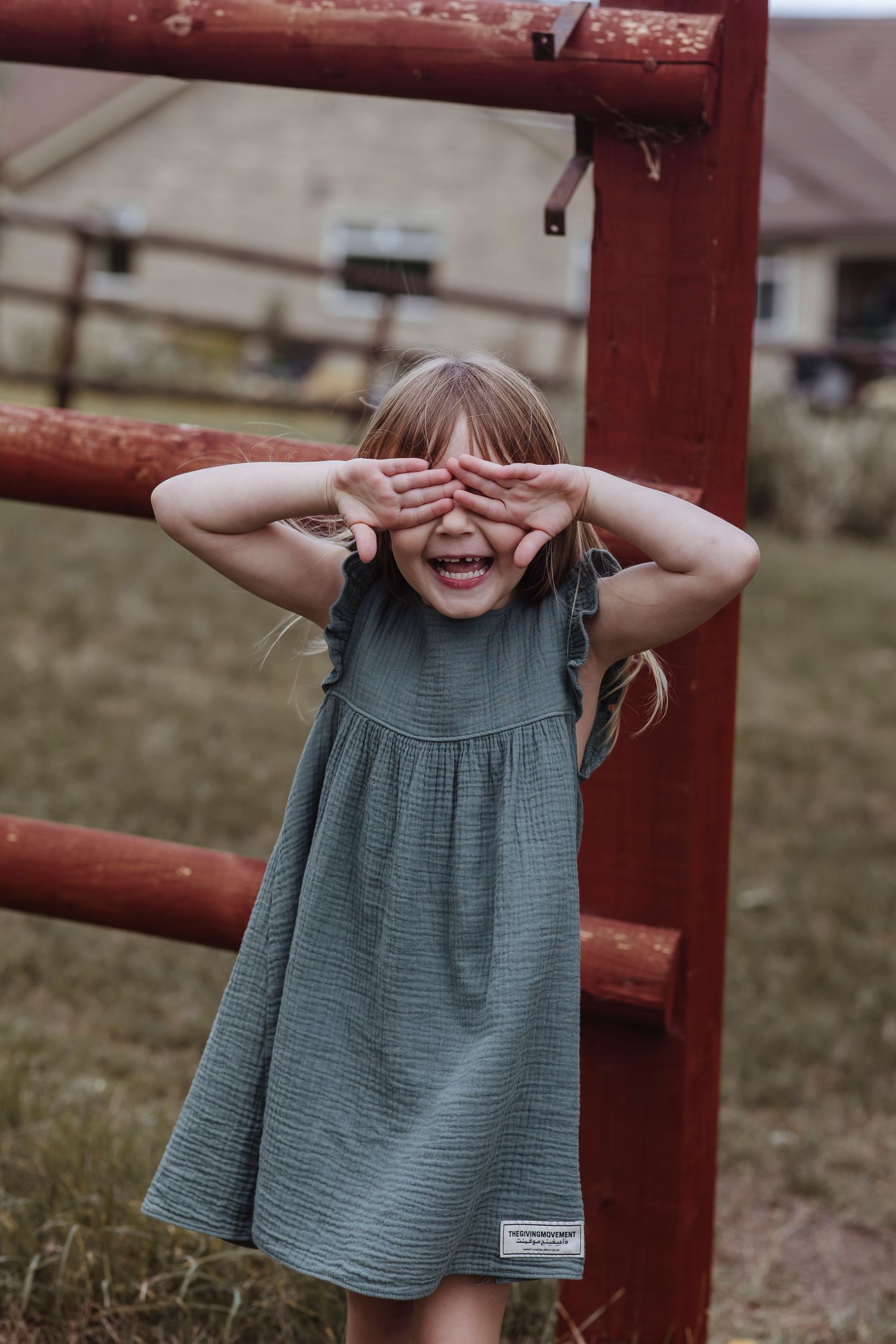 child playing hide and seek in the garden with her their brother