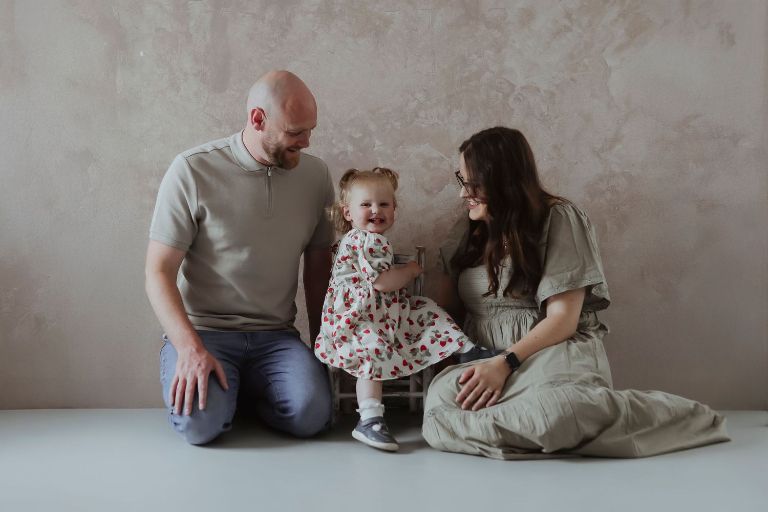 family laughing and playing in the studio
