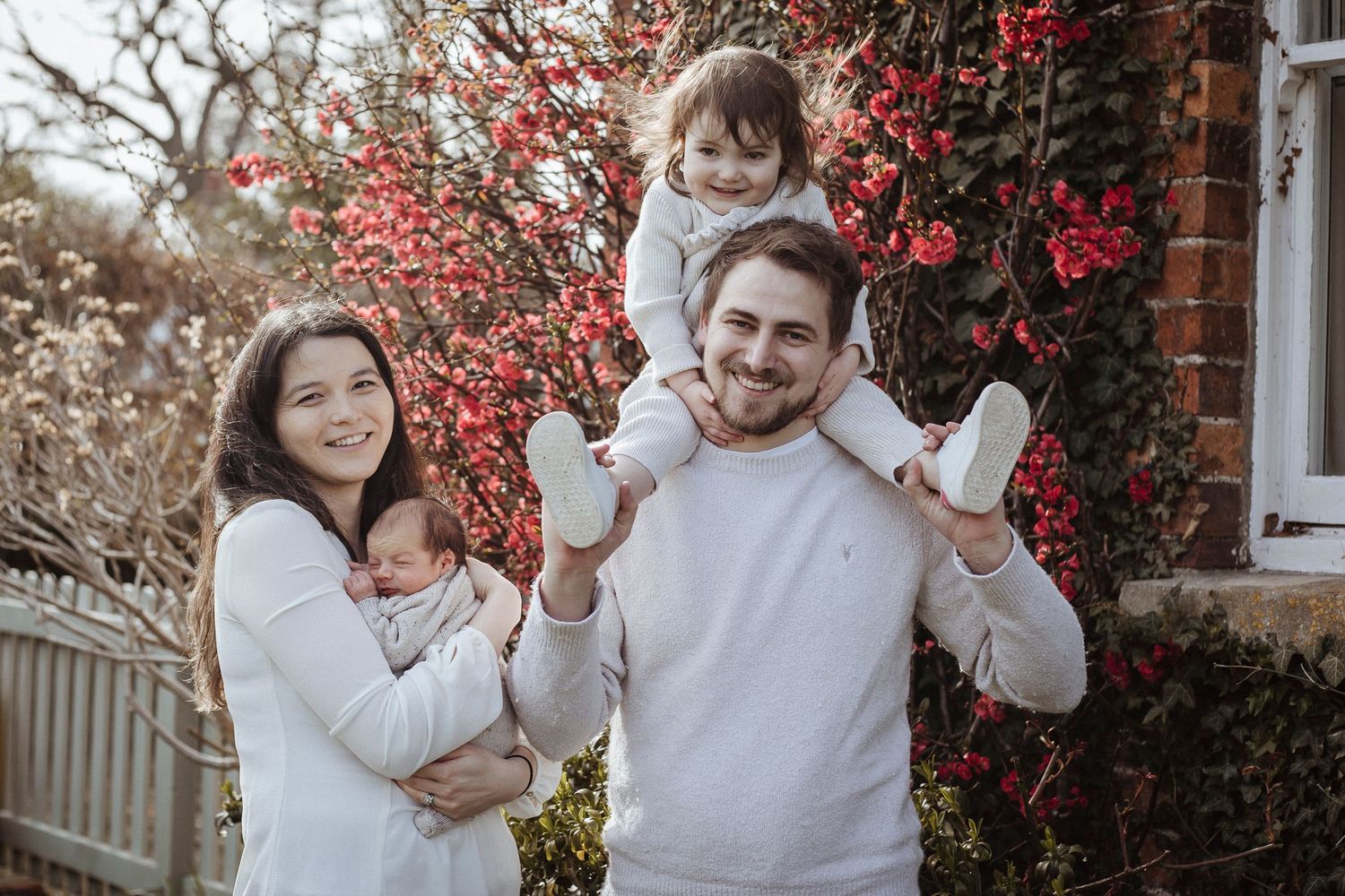 family smiling and playing in the garden