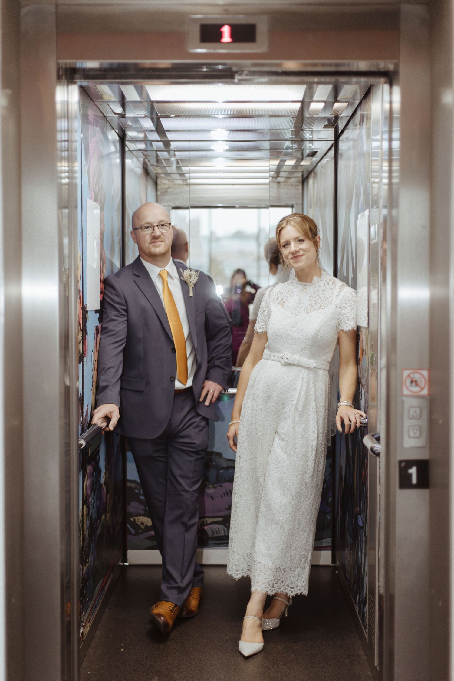 bride and groom posing in a lift