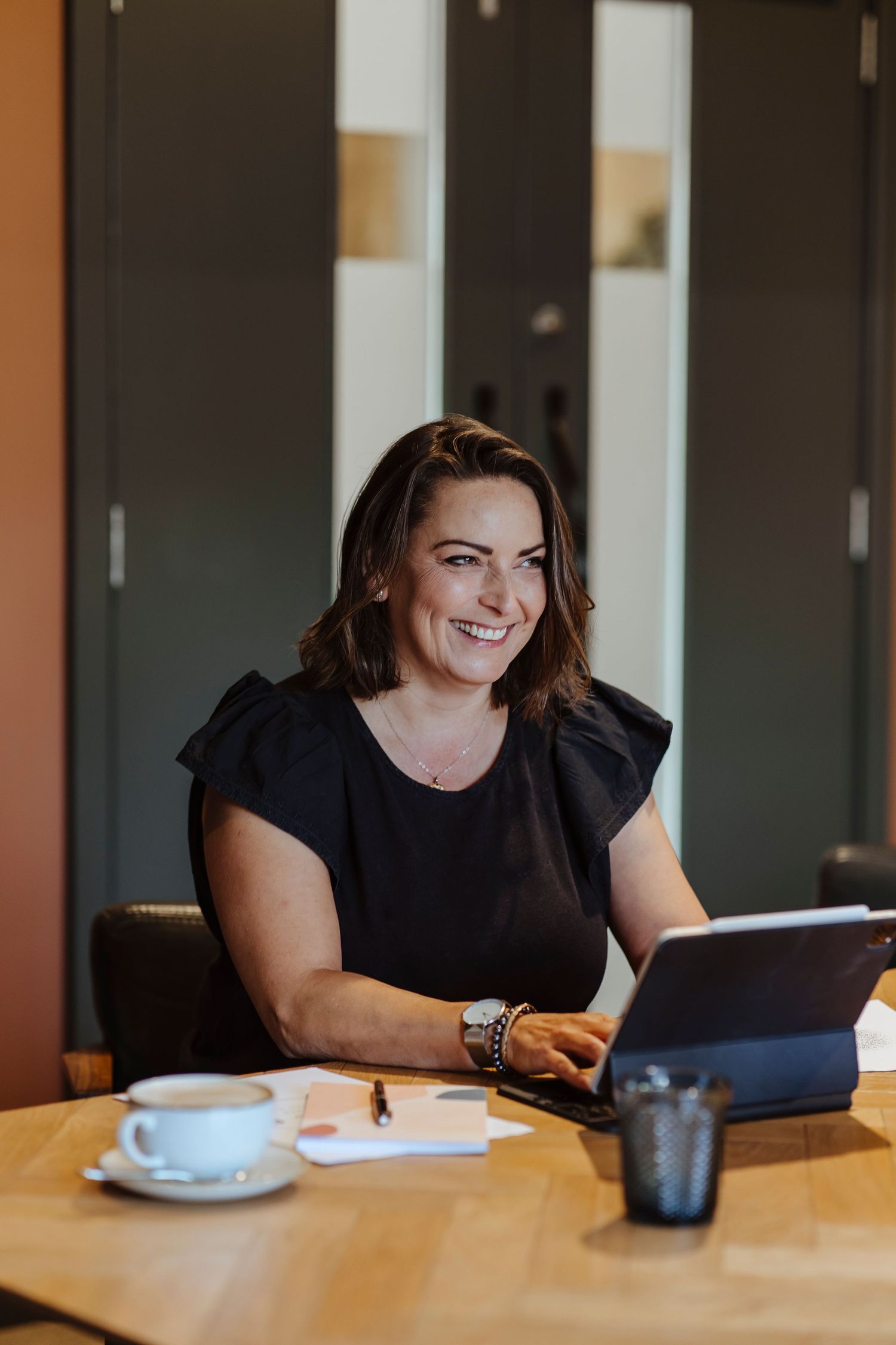 woman working on her laptop smiling