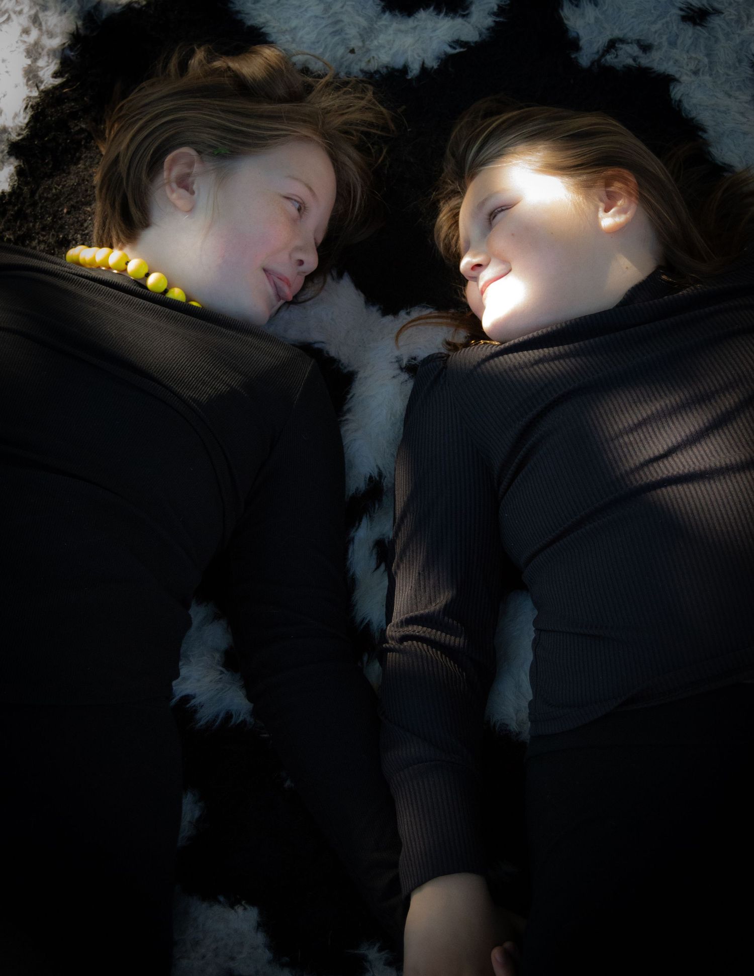 Artistic dark photo series of people resting on a textured surface with dramatic lighting.