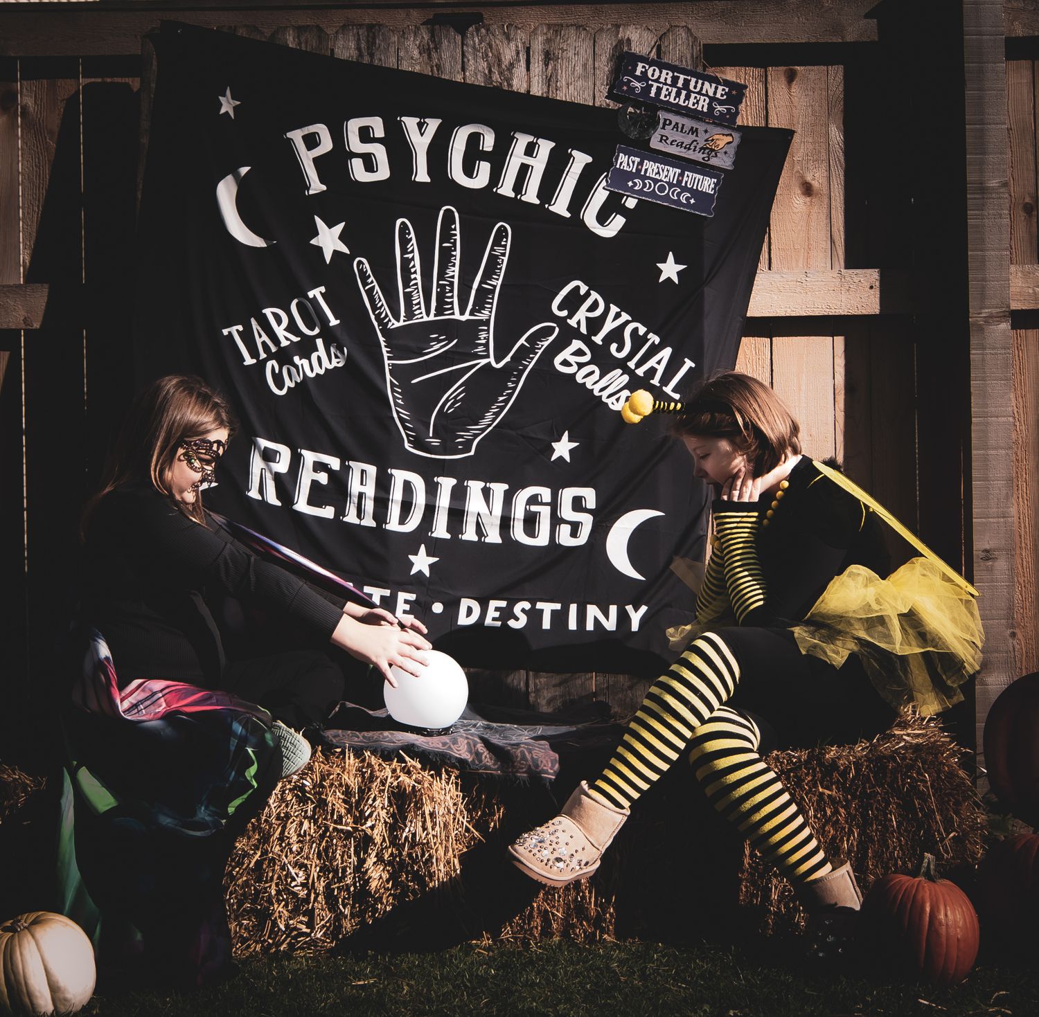 Halloween themed backdrop with psychic readings sign and decorative elements.