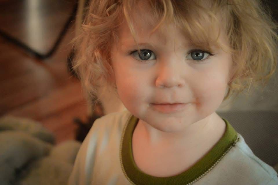 A sequence of seven close-up photos showing a child's expressive face with blonde curly hair.
