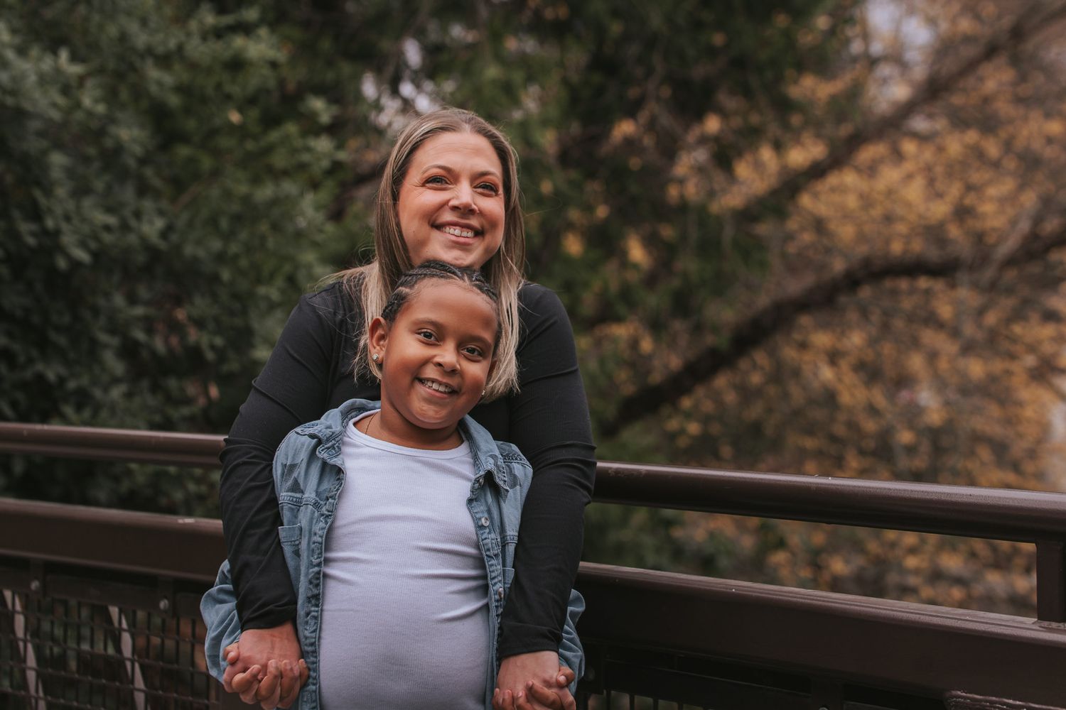 Mother and daughter portrait on a wooden bridge at Wright Park in Tacoma during a fall family photography session.