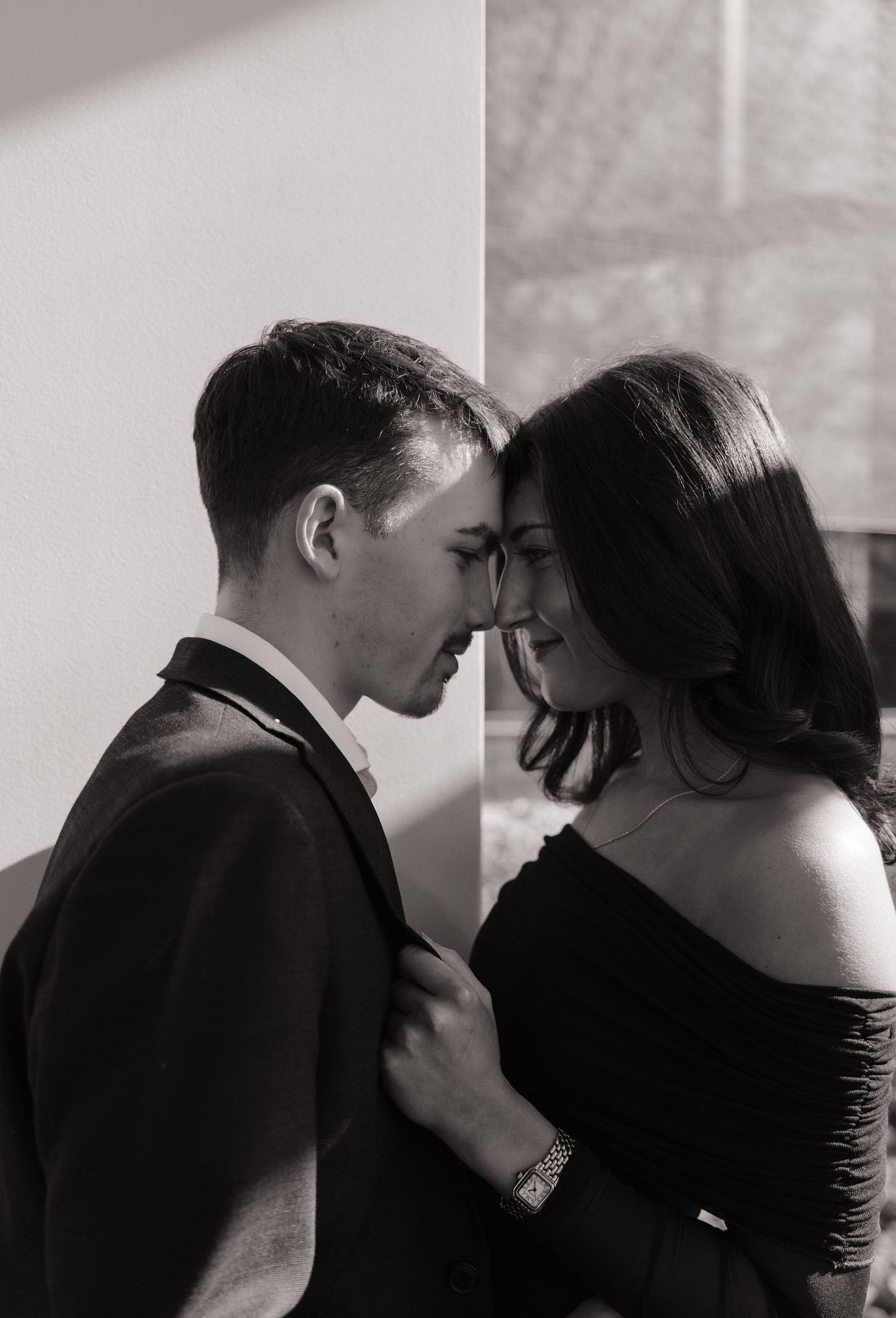 Romantic black and white portrait series showing tender intimate moments between two people.