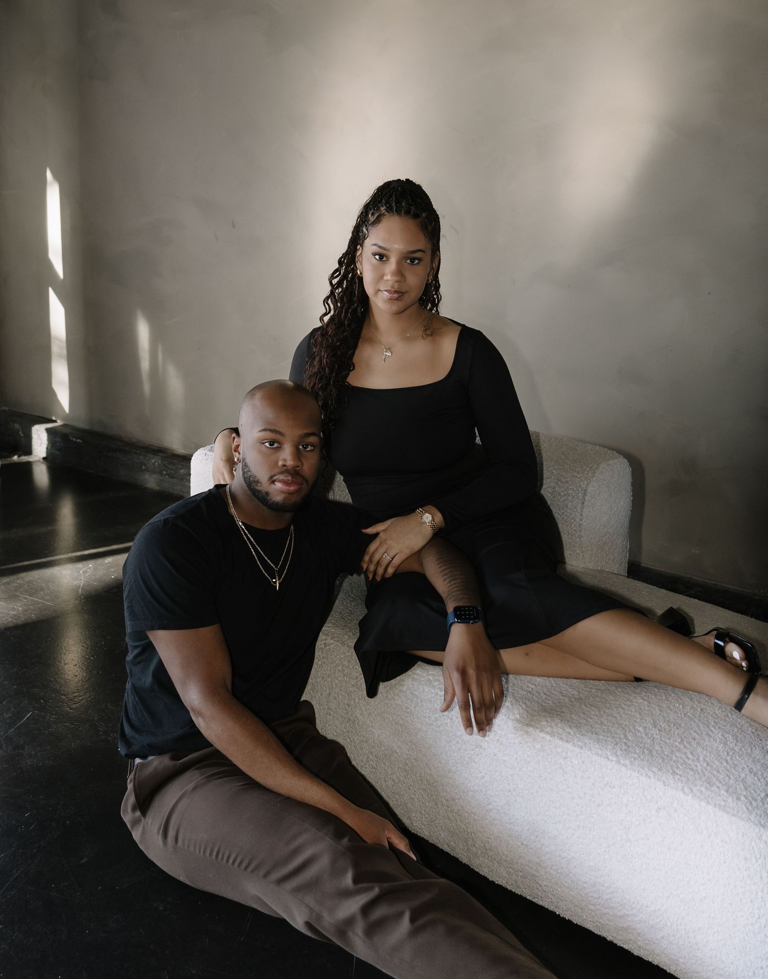 Moody indoor portrait session with dramatic window lighting and intimate poses.