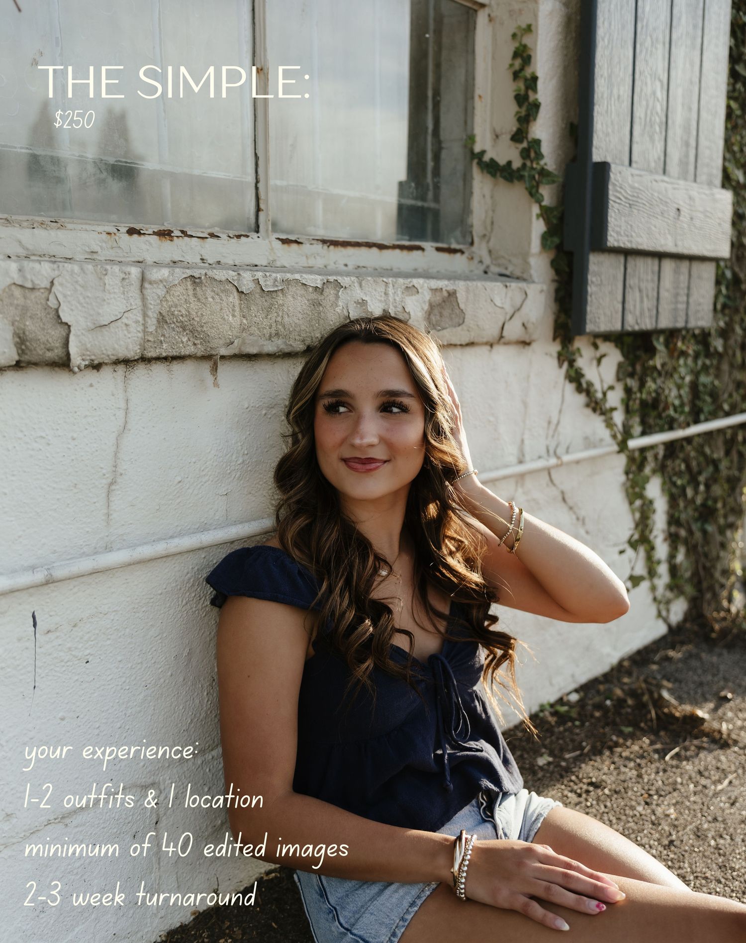 Young woman in navy top and denim shorts poses against a rustic white wall for a senior photography package priced at $250.