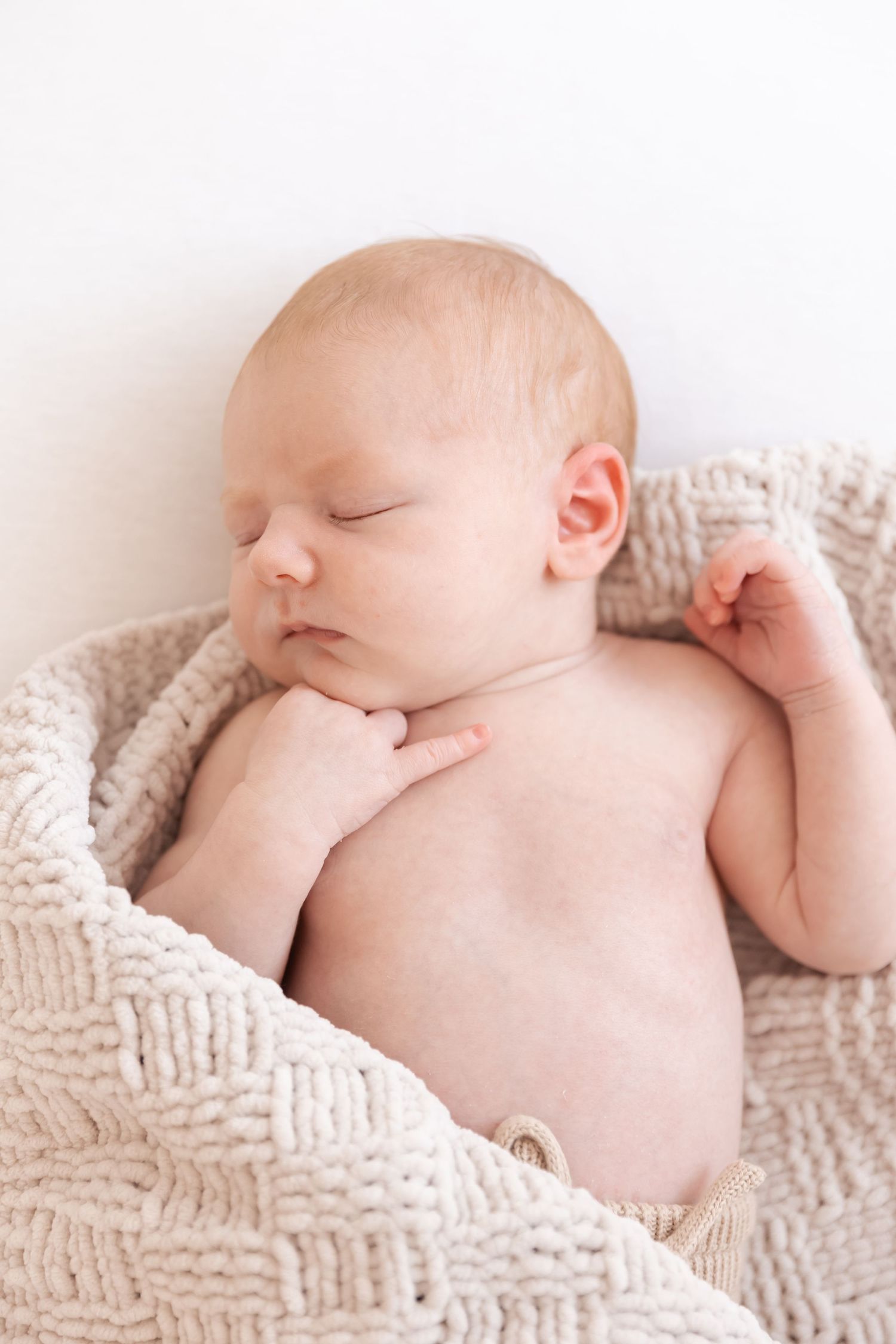 newborn baby boy sleeping on a blanket