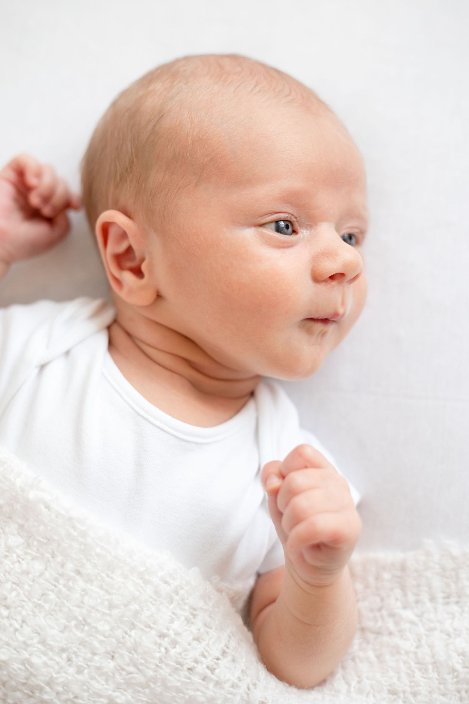 newborn baby boy lying with a blanket