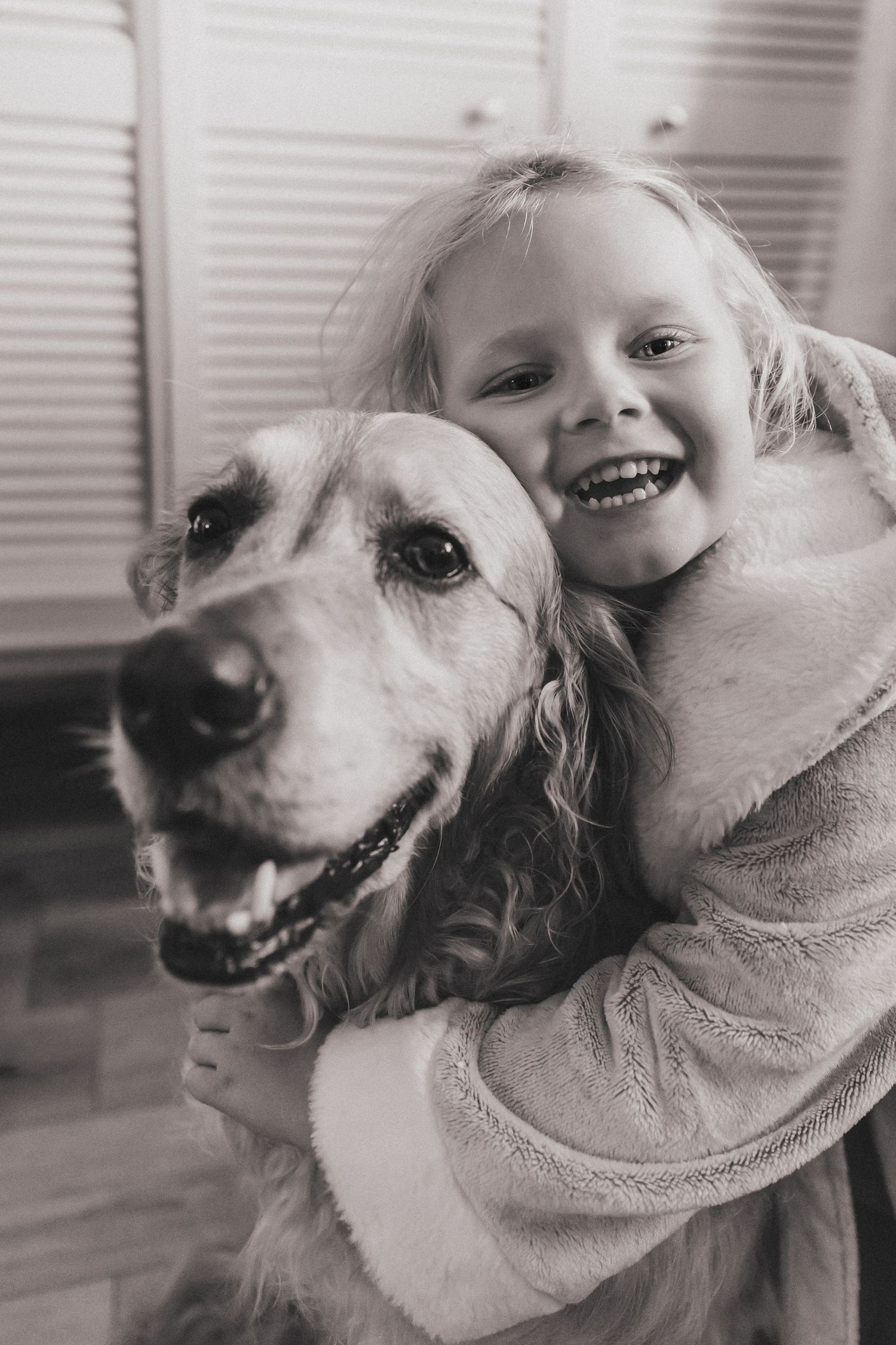 Girl and golden retriever dog cuddling