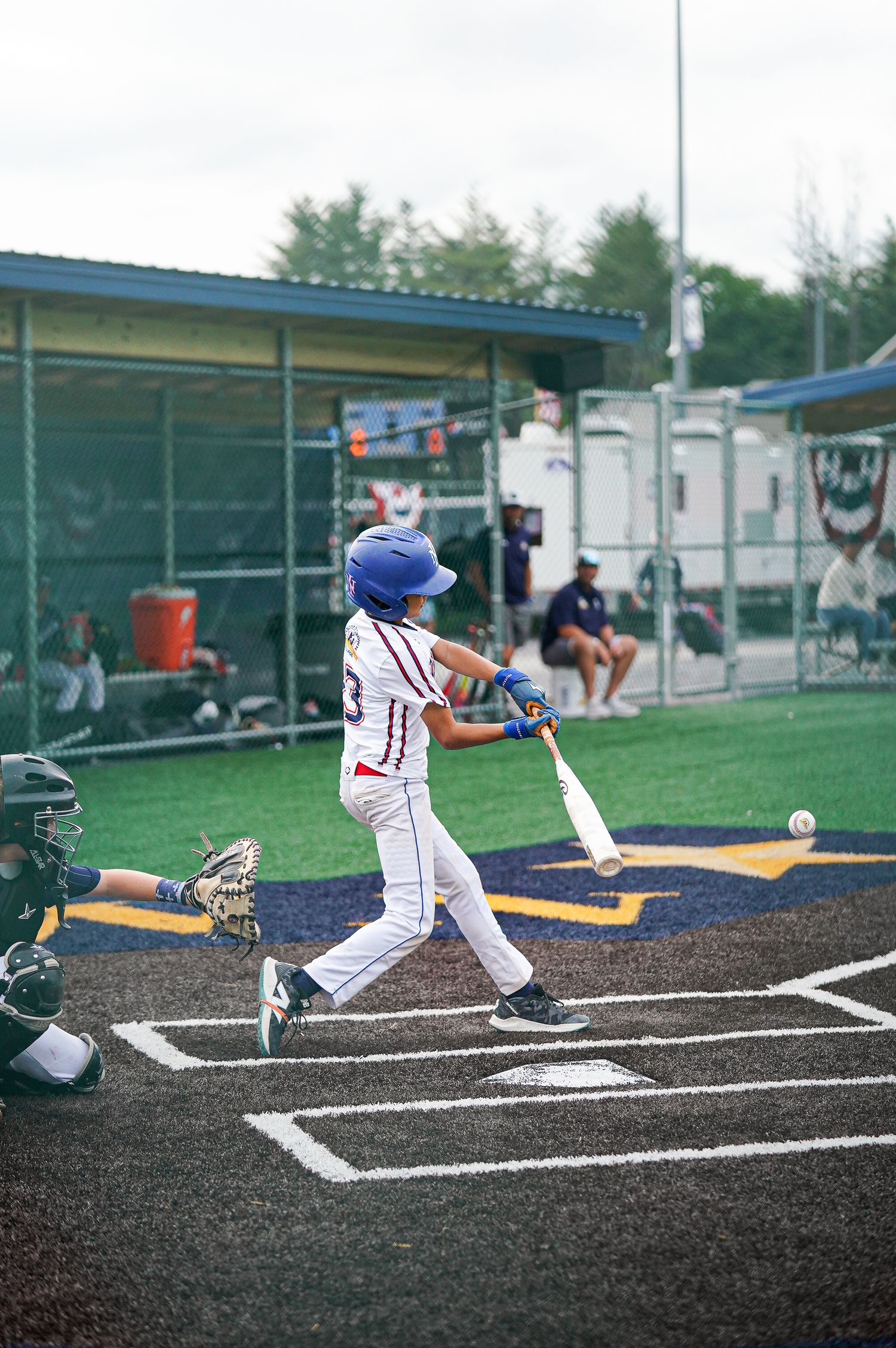 Baseball player sliding into home plate during game action.
