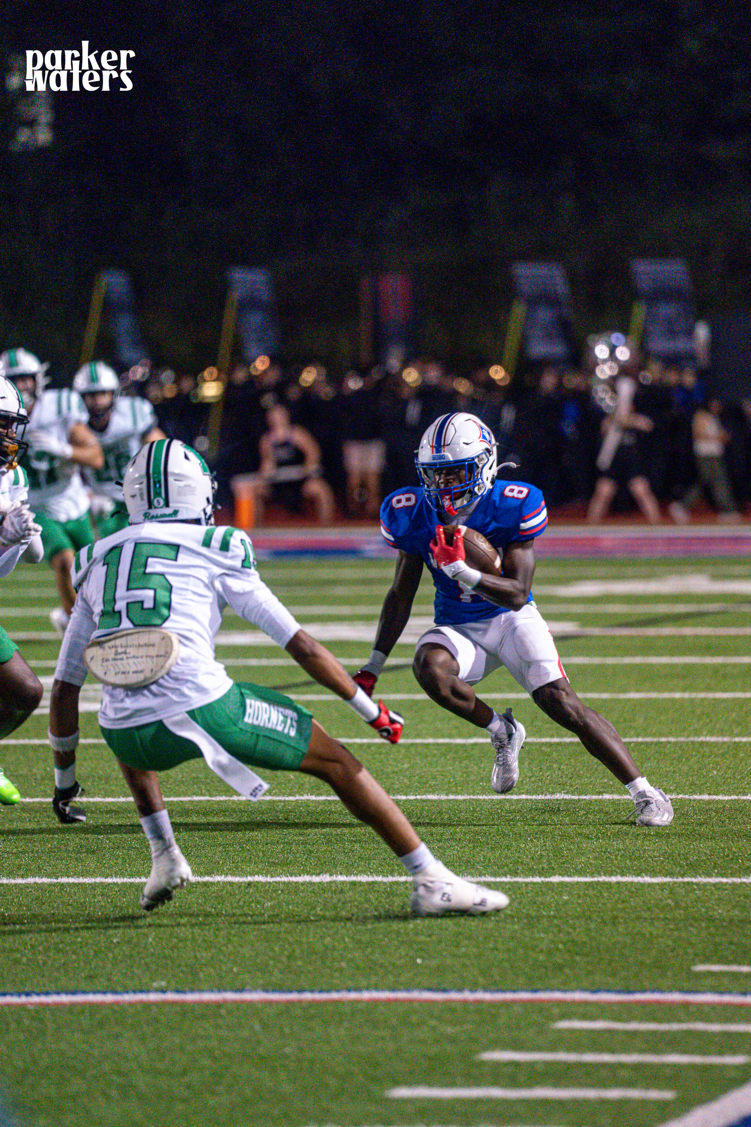 Players dive and tackle during an intense football play on the field.