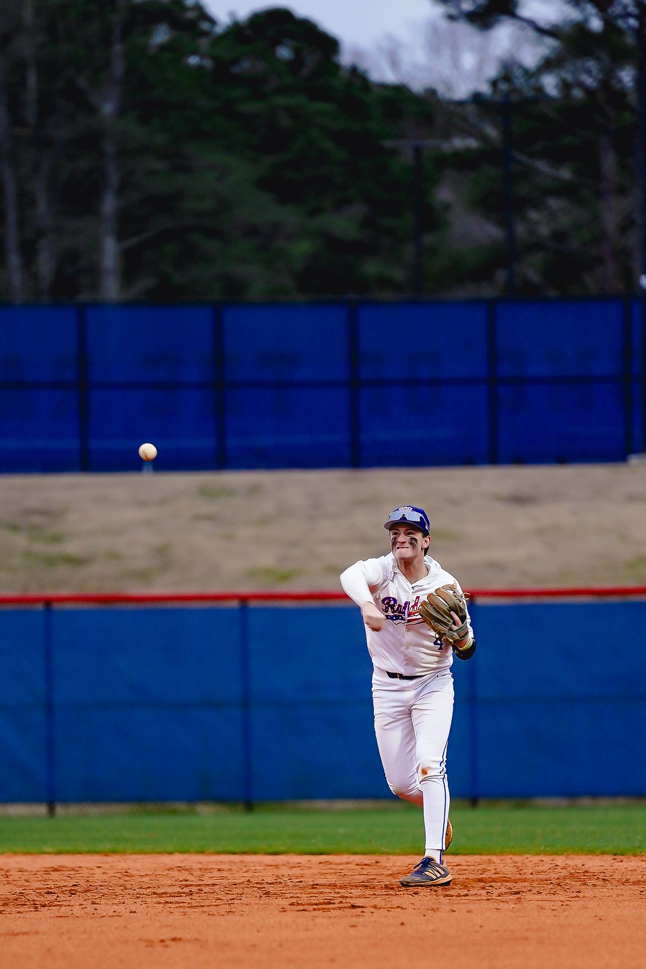 Baseball infielders position themselves on a baseball diamond during a game.