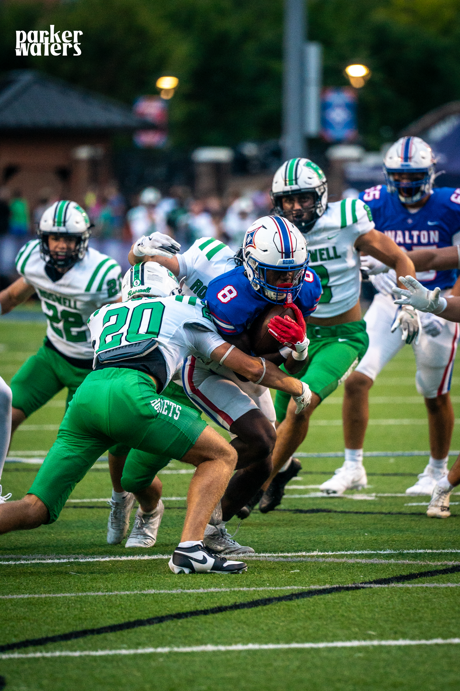 Football players line up in defensive positions on the field during a game.