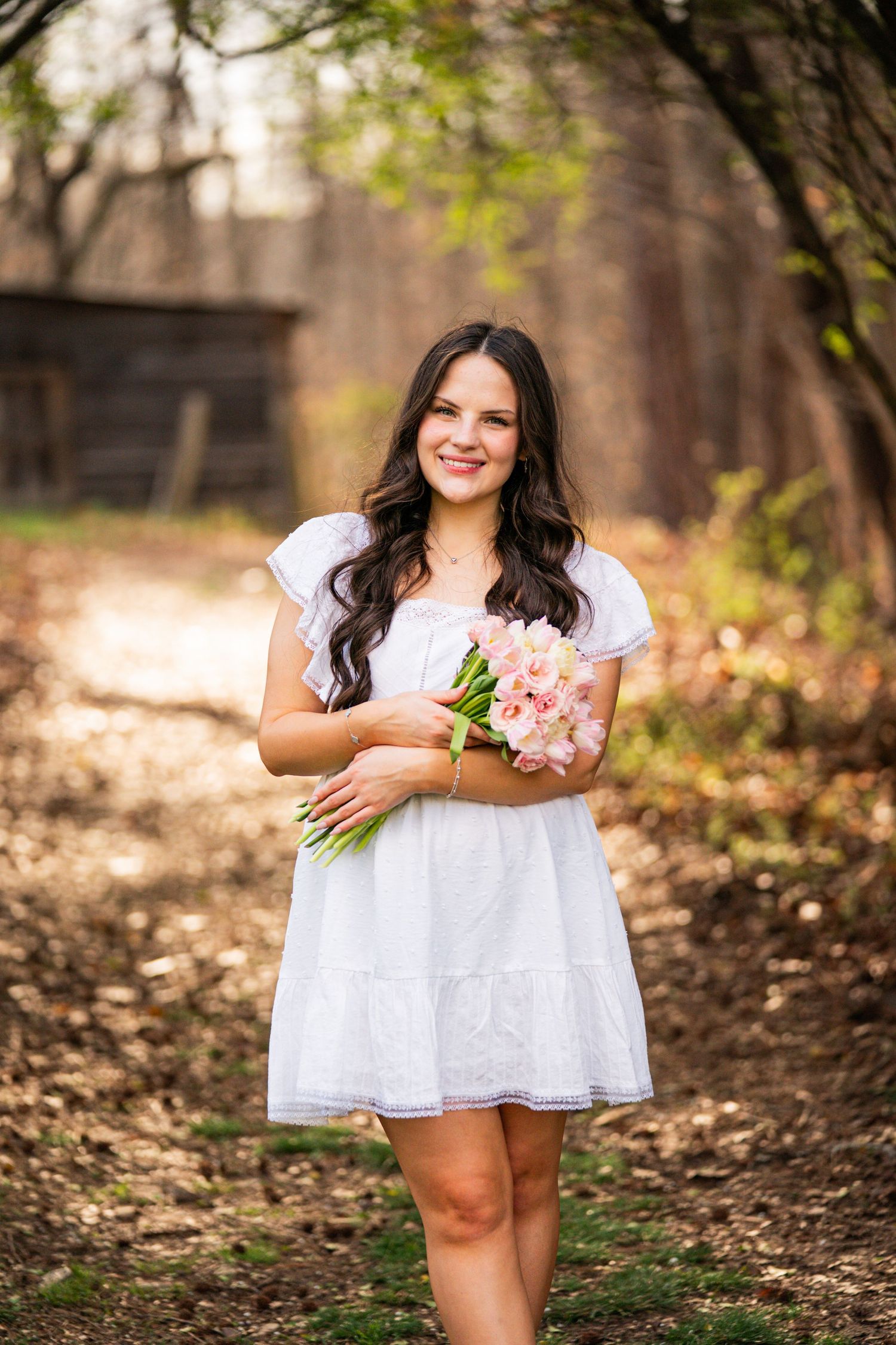 A series of photos showing a person in a white dress twirling and posing playfully in a wooded outdoor setting.