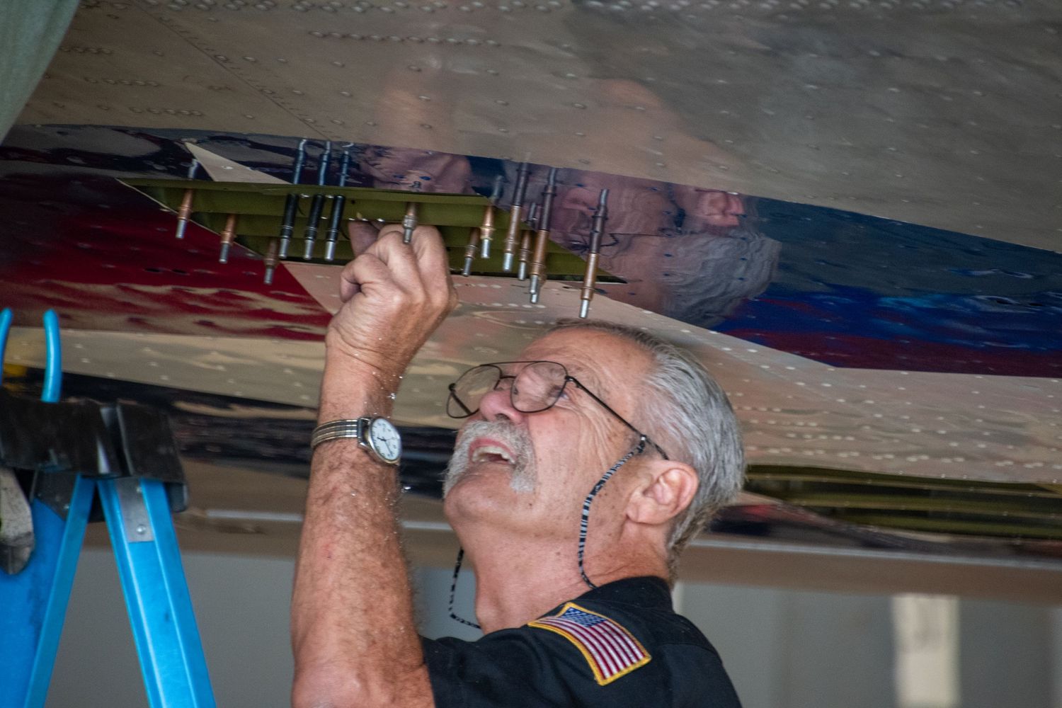 A volunteer inspects B-17 Sentimental Journey.