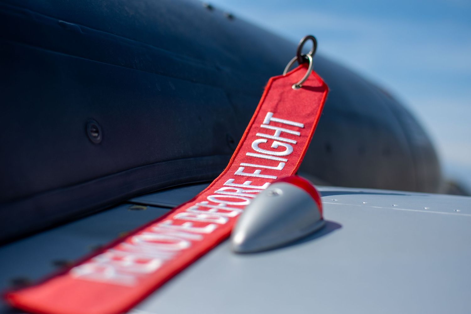 Remove Before Flight streamer on vintage WWII airplane.