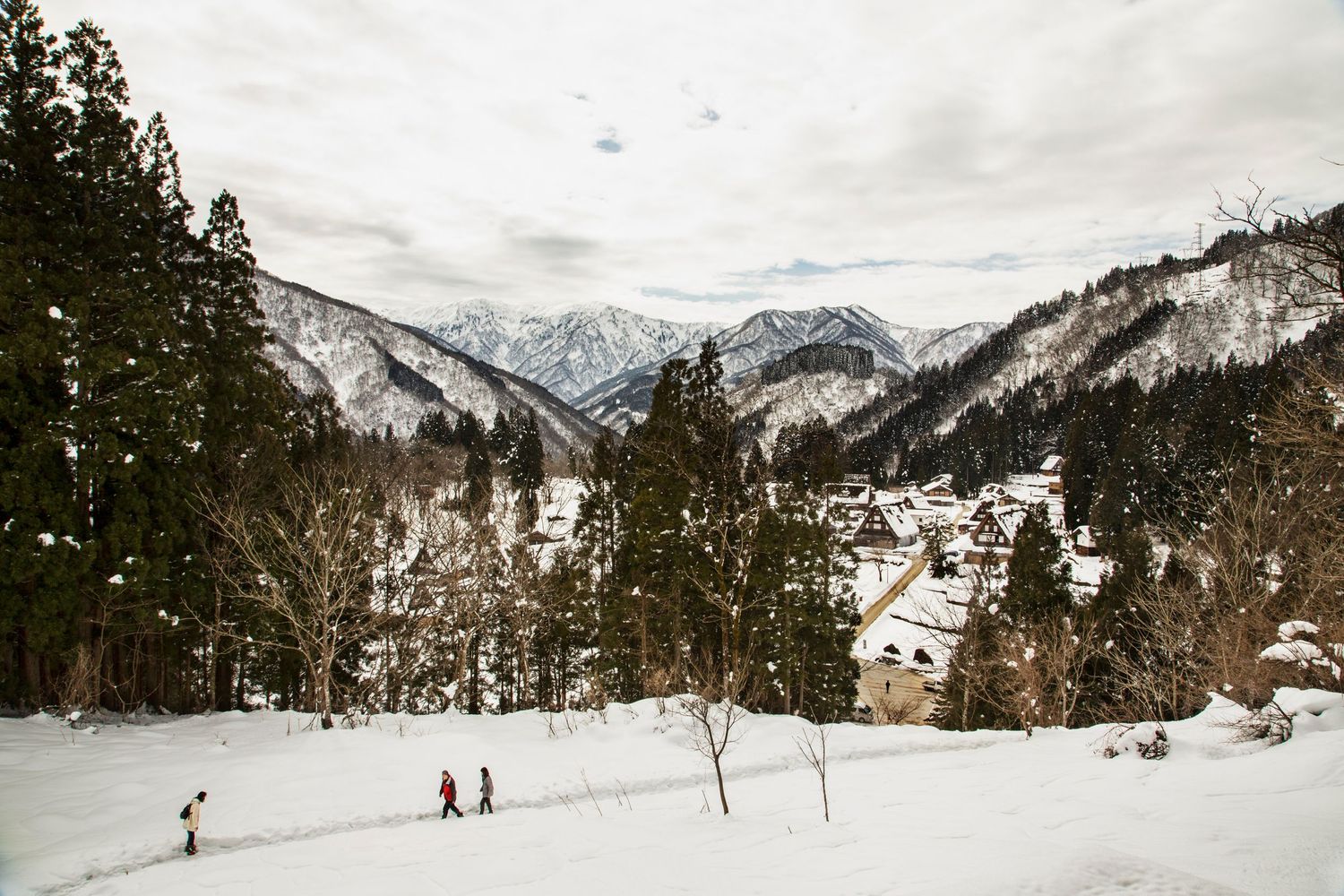 Snow-covered mountain slopes with skiers and winter sports enthusiasts enjoying the scenic landscape.