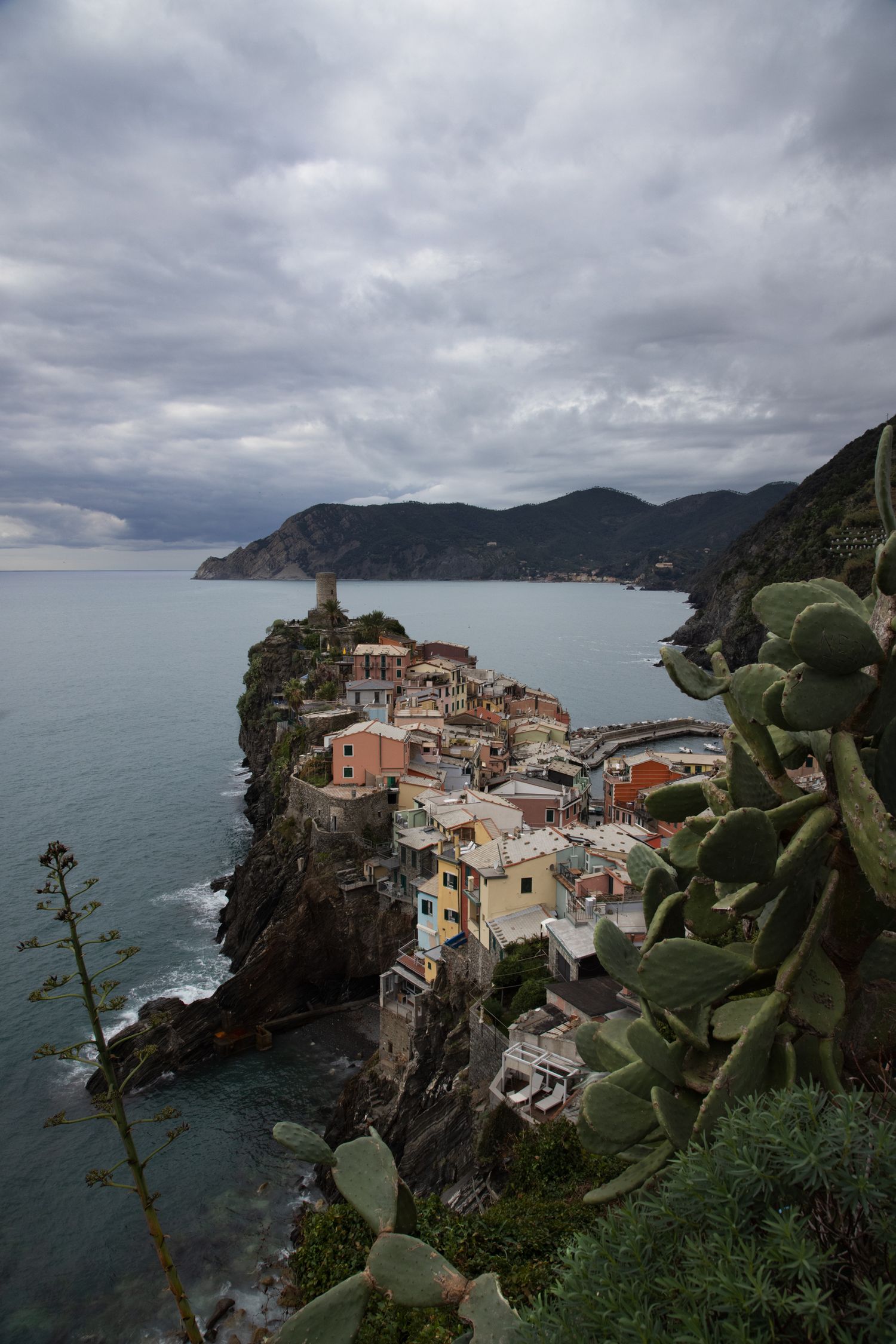 Aerial view of colorful Vernazza village perched on rocky cliffs overlooking the Ligurian Sea in Cinque Terre, Italy.